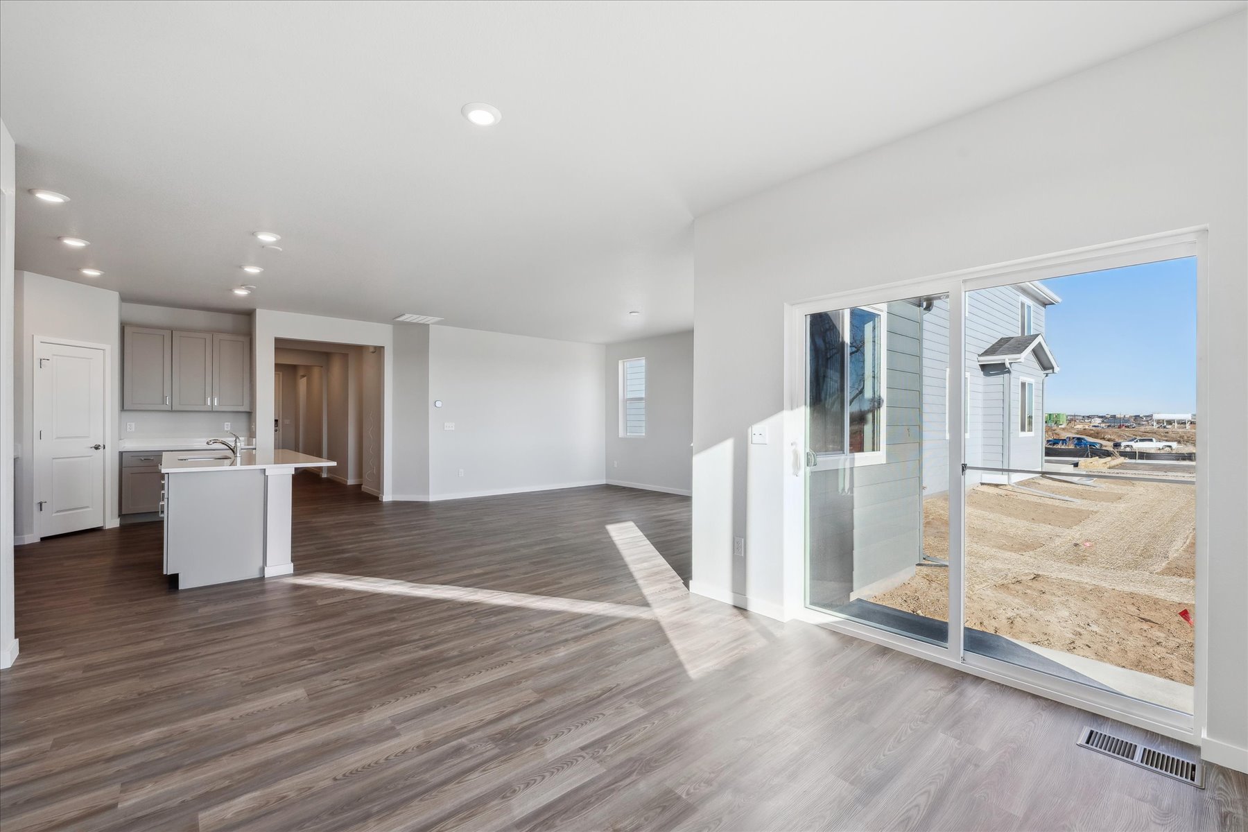 A large kitchen with a large glass door.