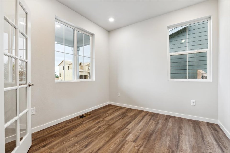 A room with a wood floor and a window.