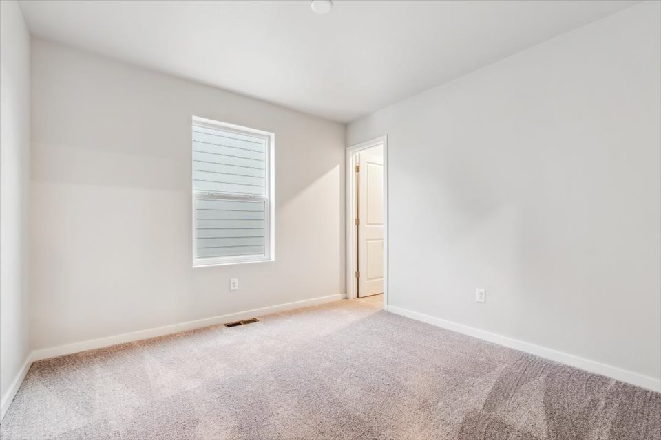 A room with a door and a carpet.