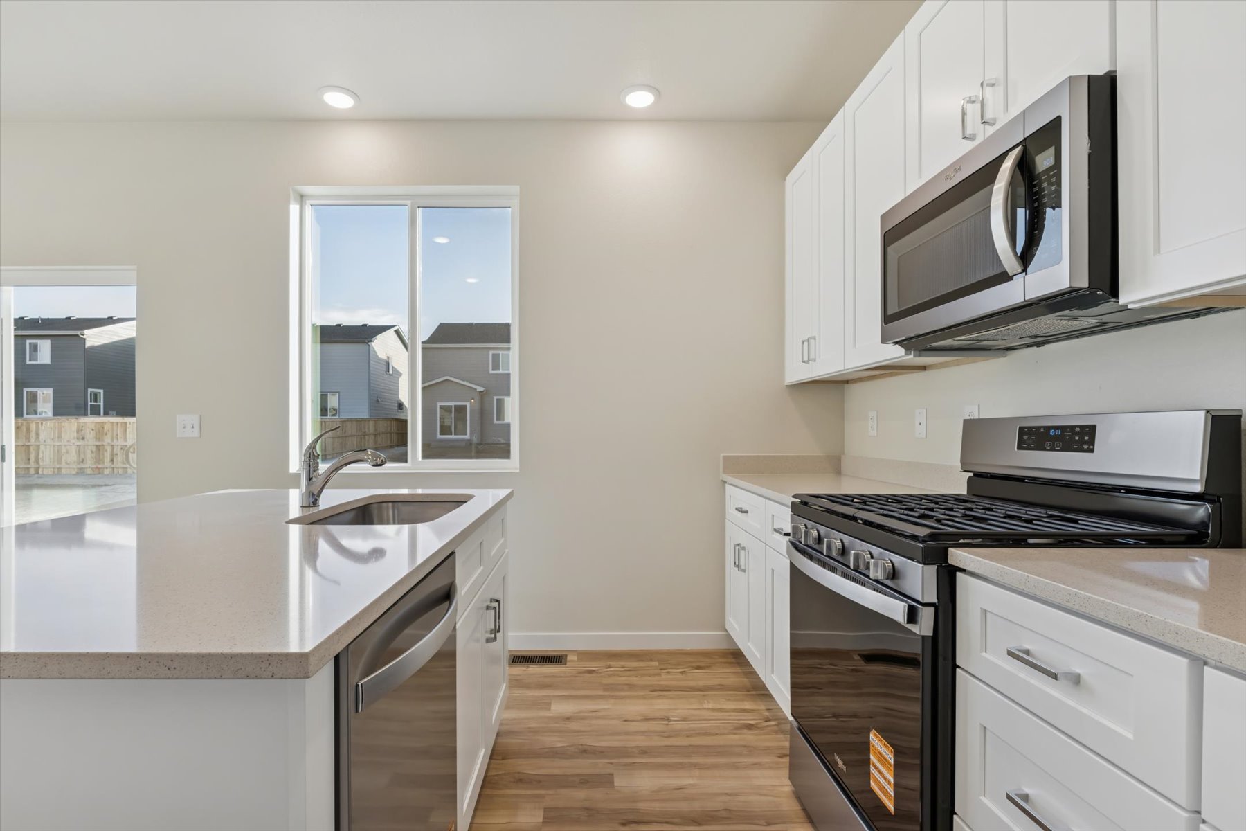 A kitchen with white cabinets.