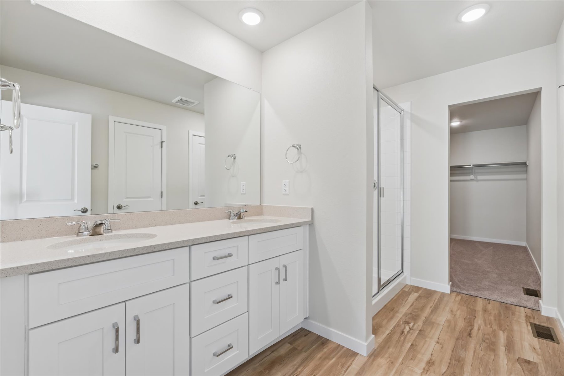 A bathroom with white cabinets.
