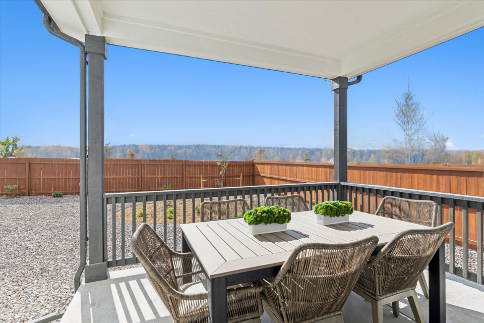 A table and chairs on a deck.