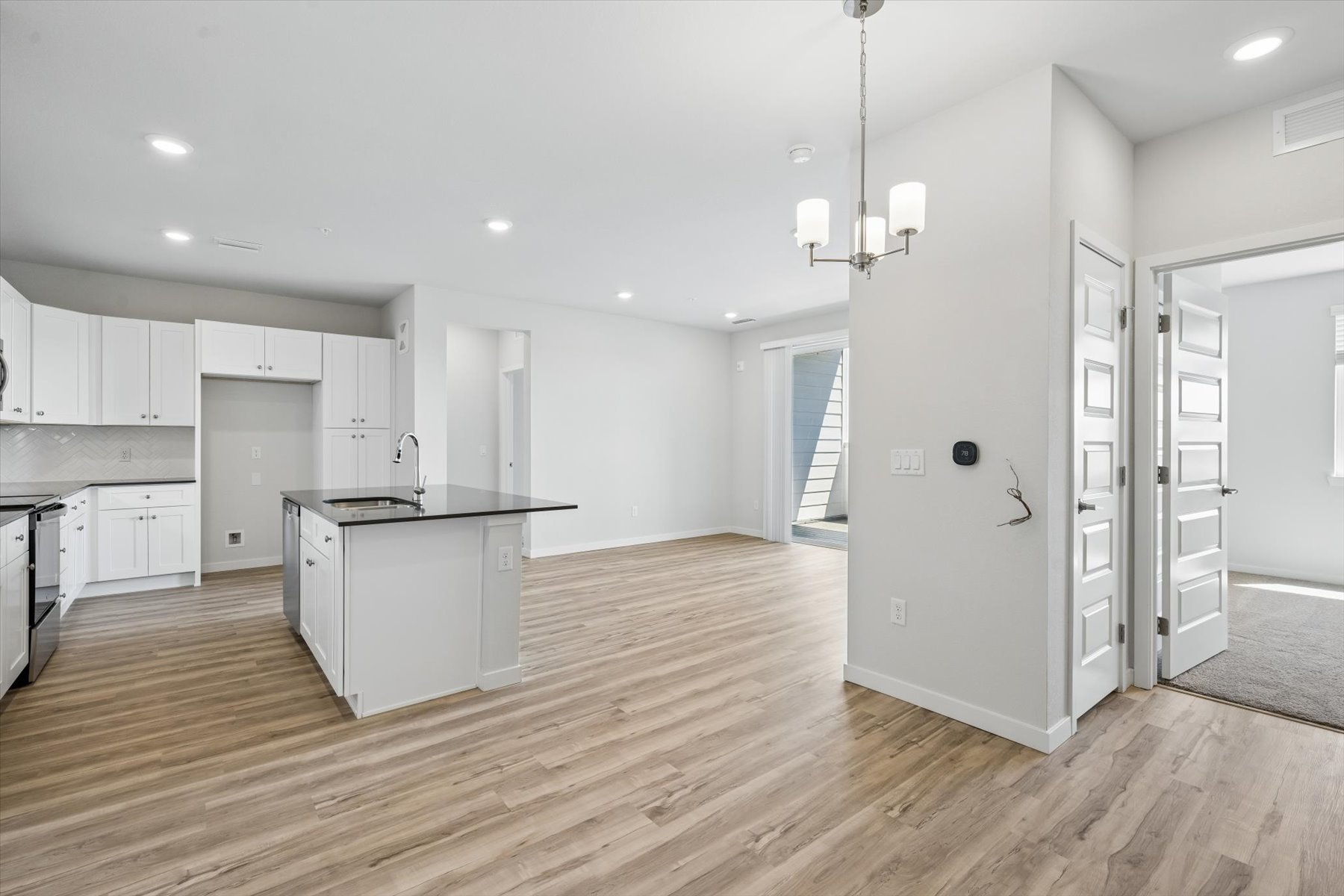 A large kitchen with white cabinets.