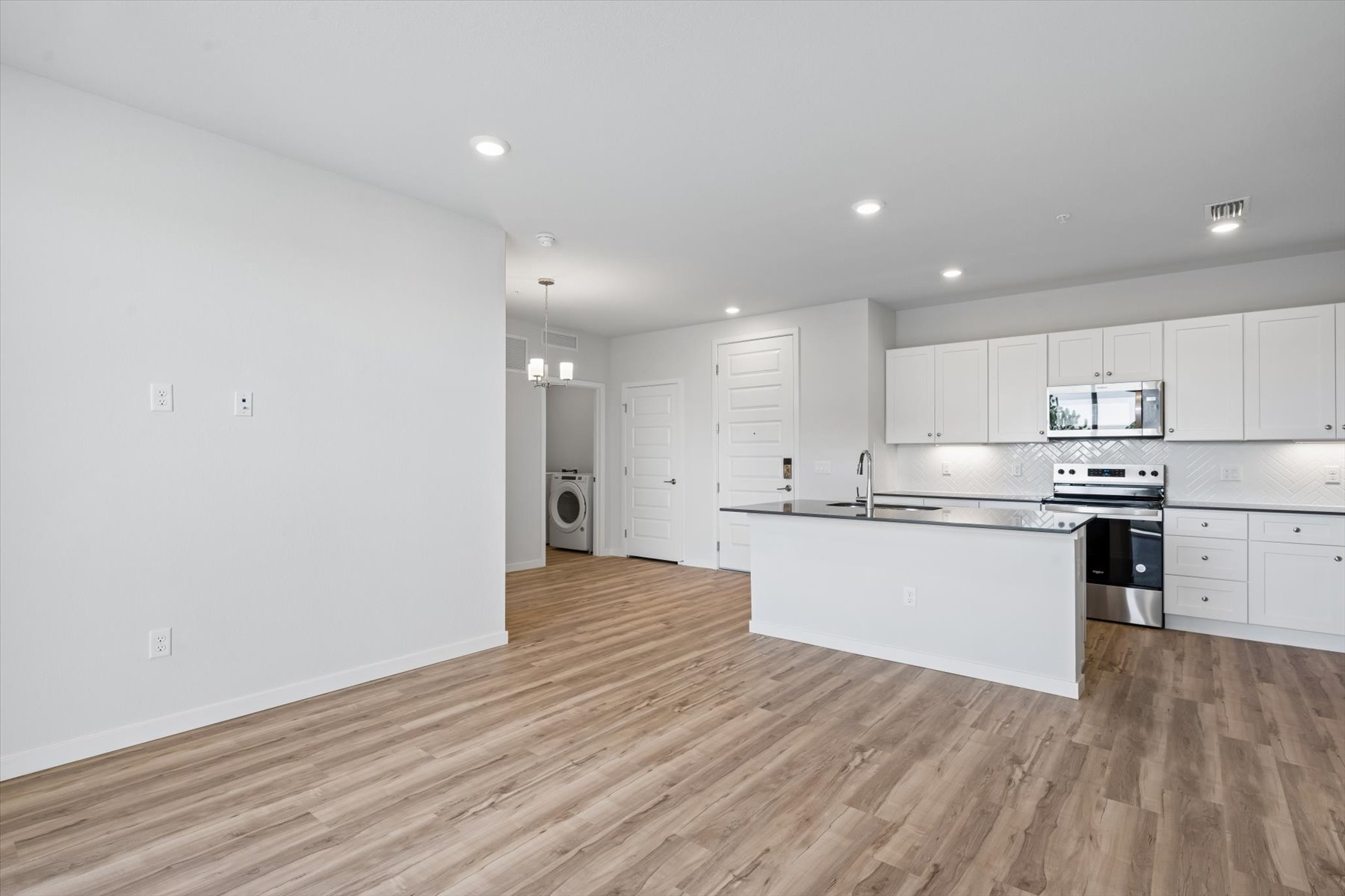 A kitchen with white cabinets.