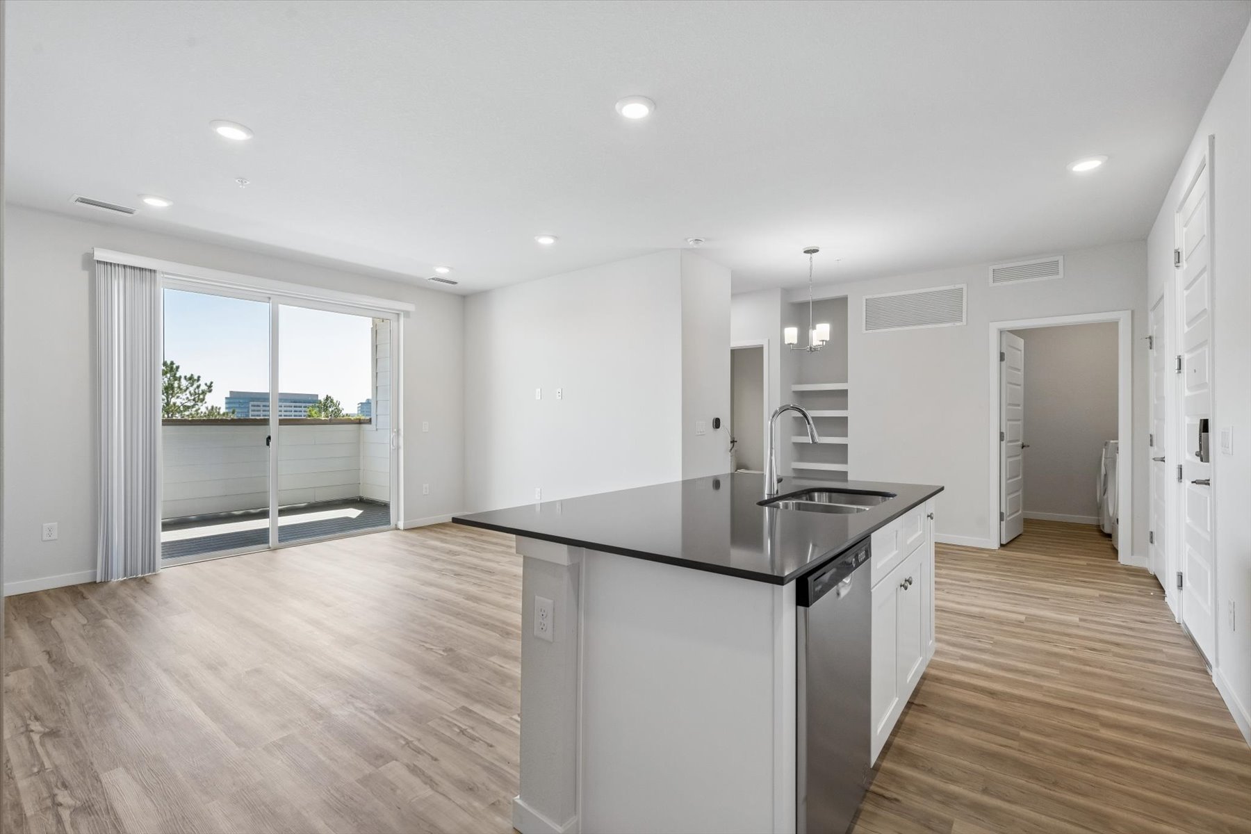 A kitchen with white cabinets.