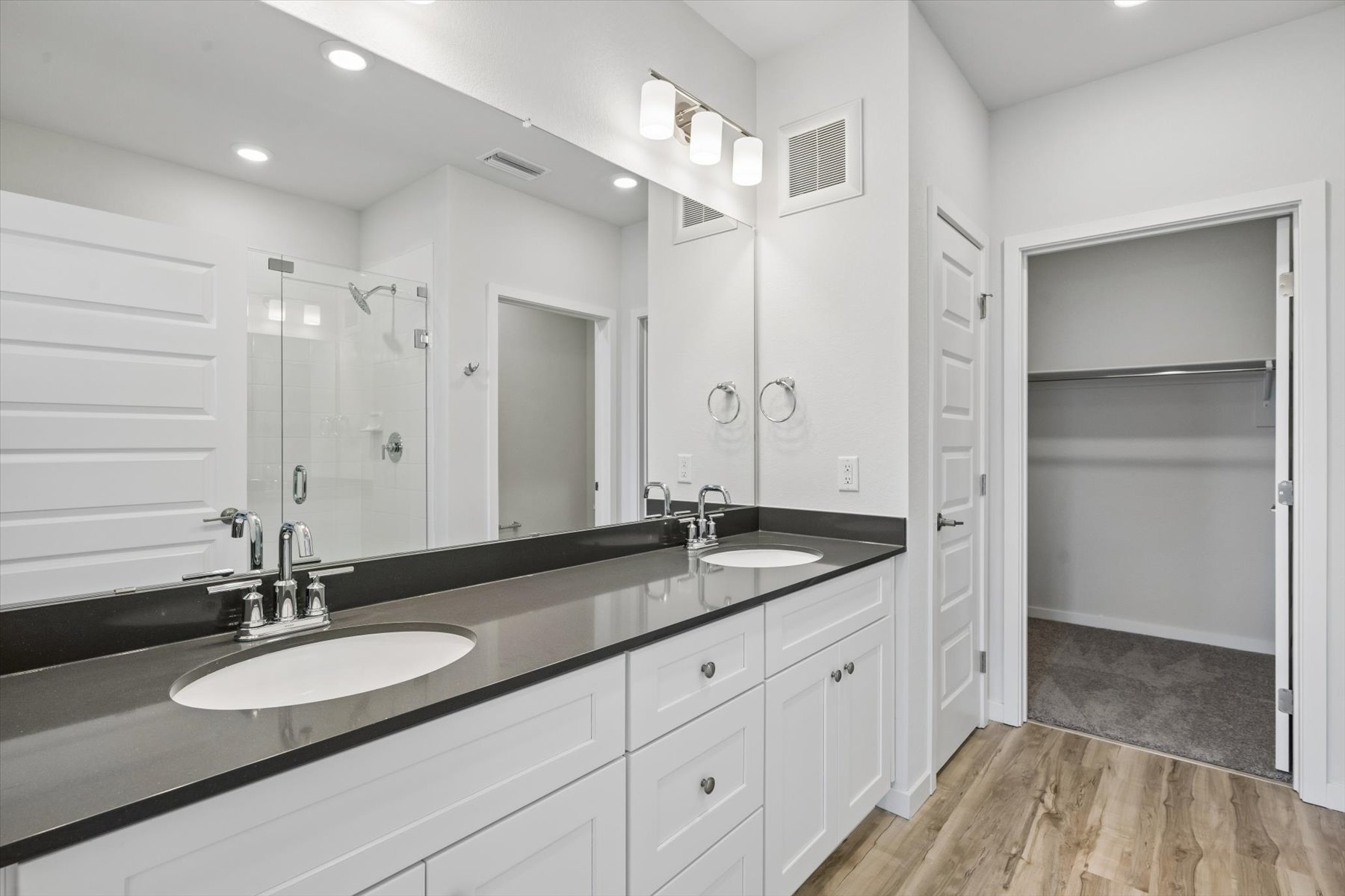 A bathroom with a large mirror.