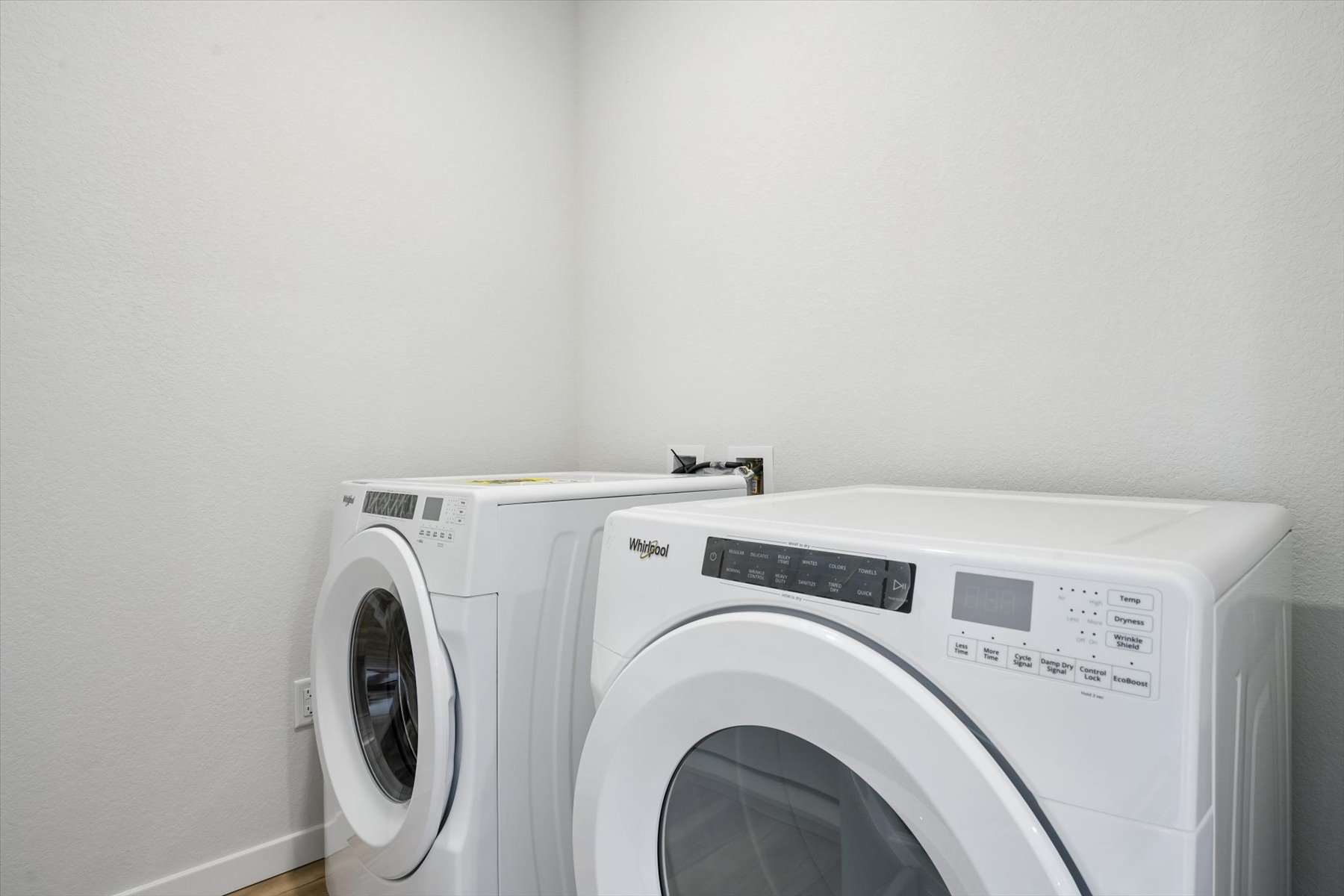 A washing machine in a room.