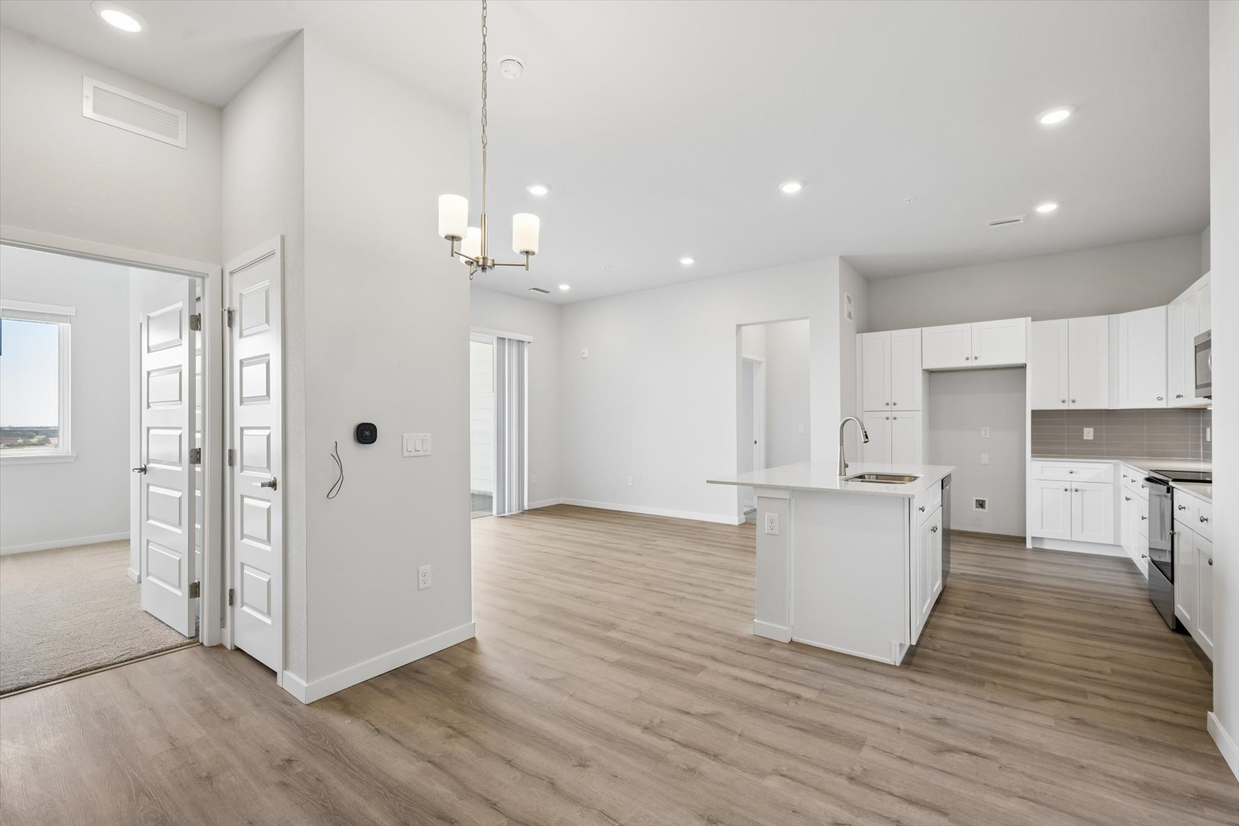 A large kitchen with white cabinets.