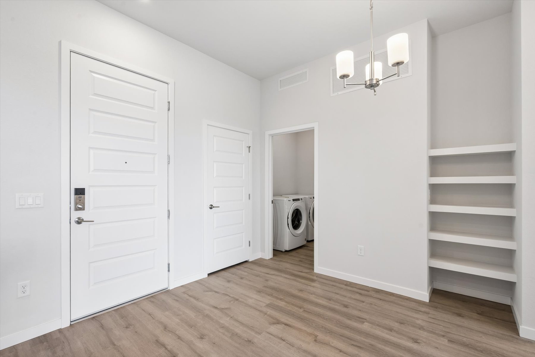 A room with white doors and a white staircase.