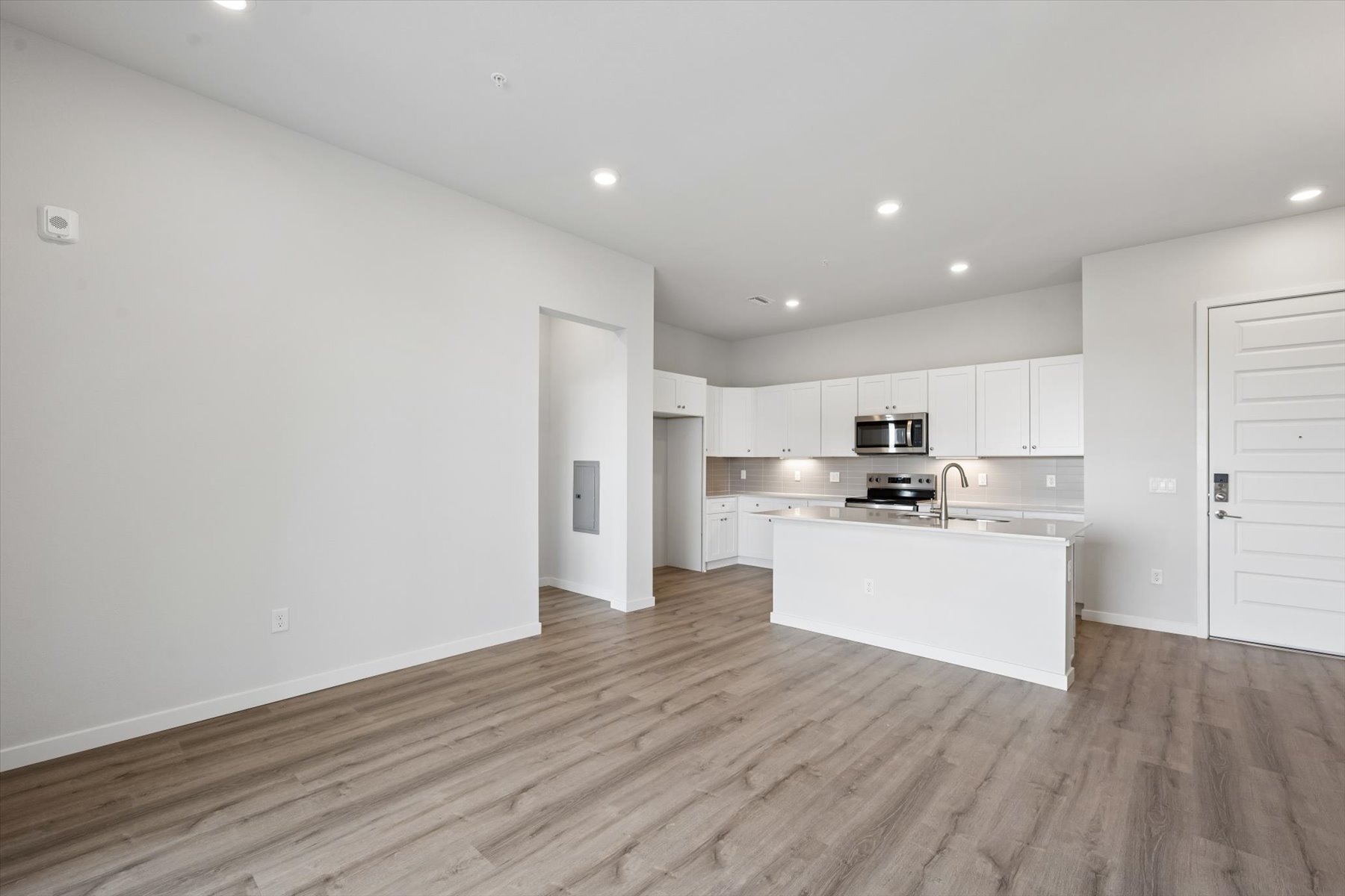A kitchen with white cabinets.