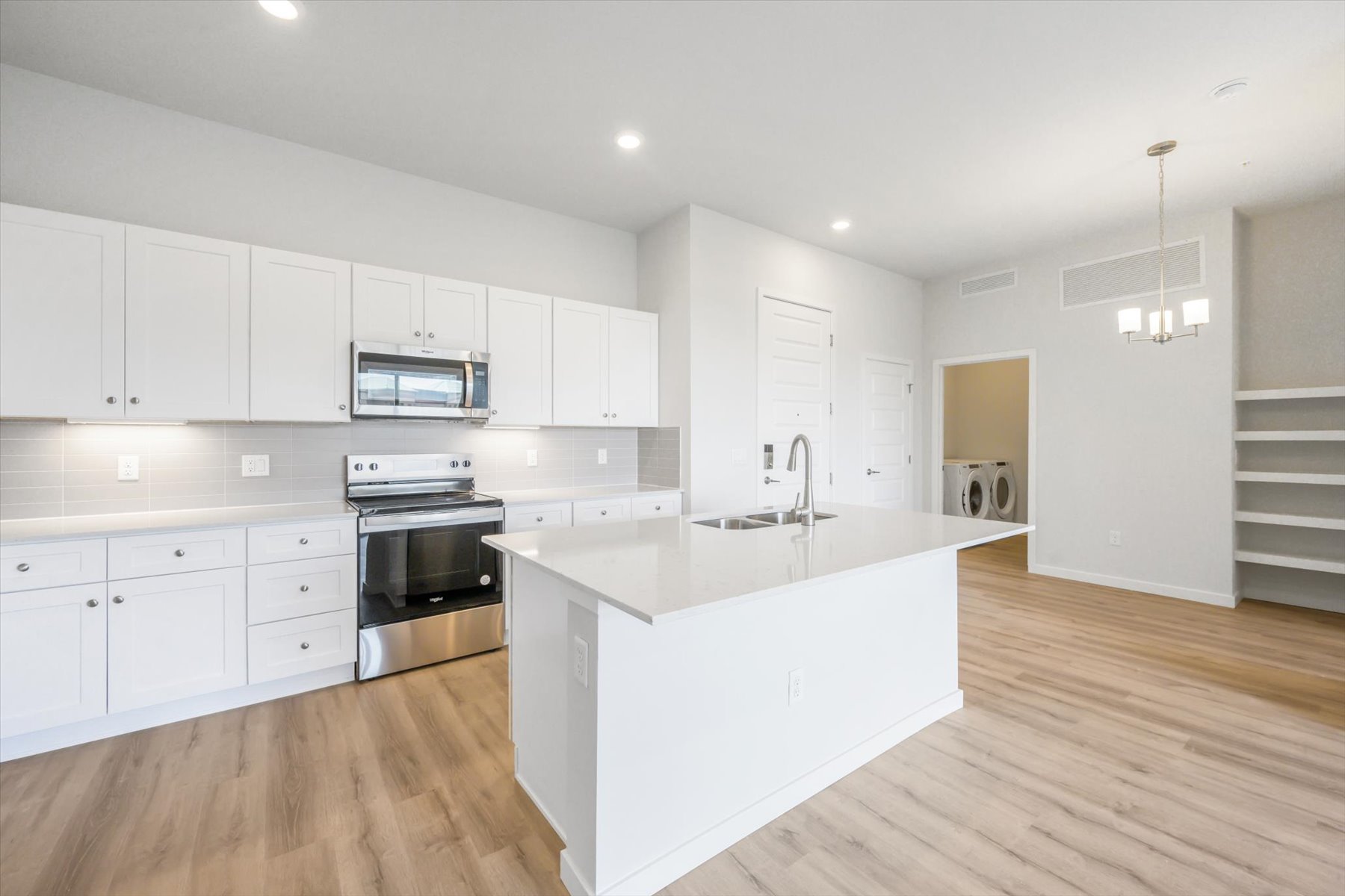 A kitchen with white cabinets.