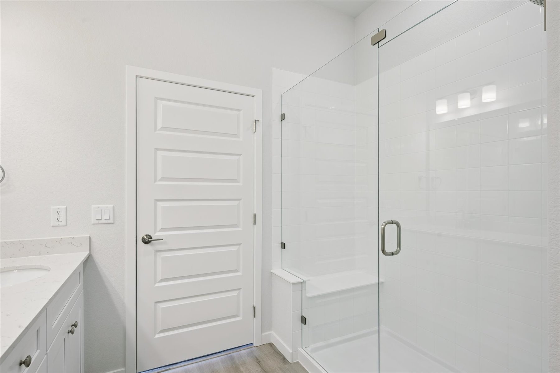 A white door next to a white door.