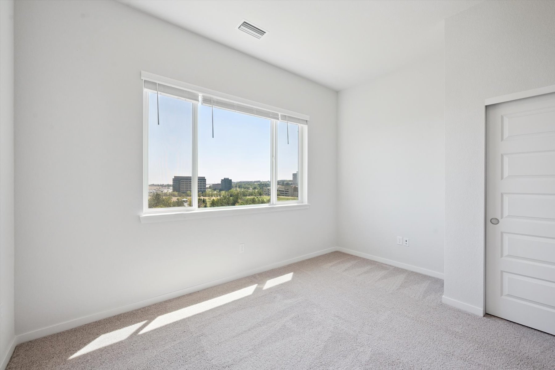 A room with a window and a door.