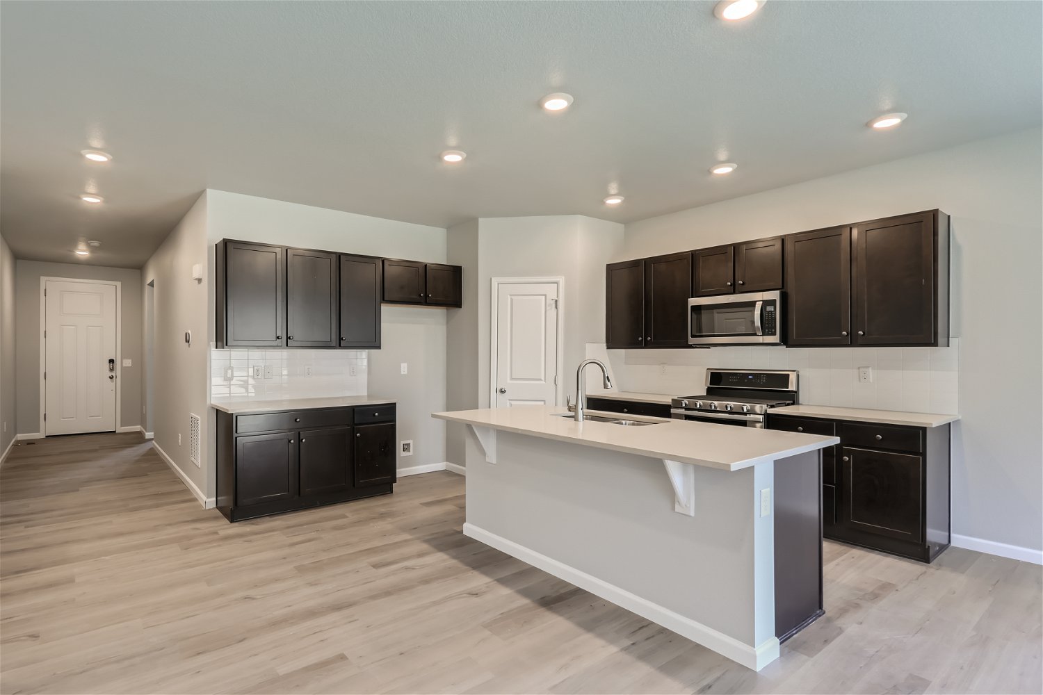 A kitchen with black cabinets.