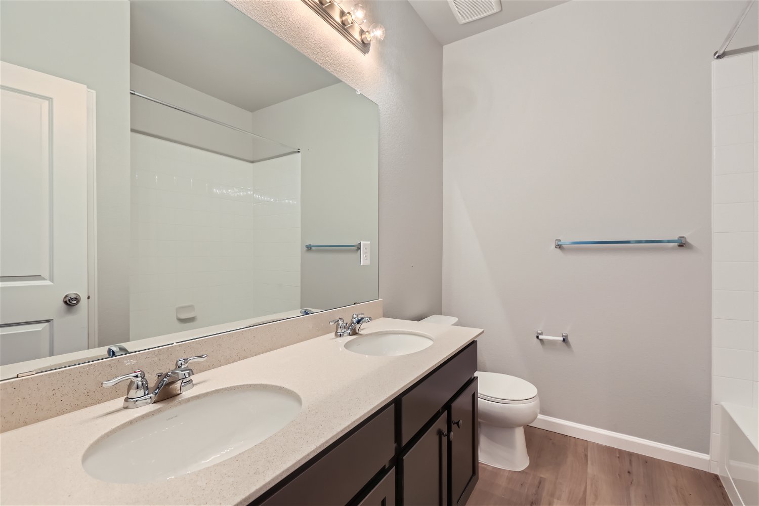 A bathroom with a large mirror.
