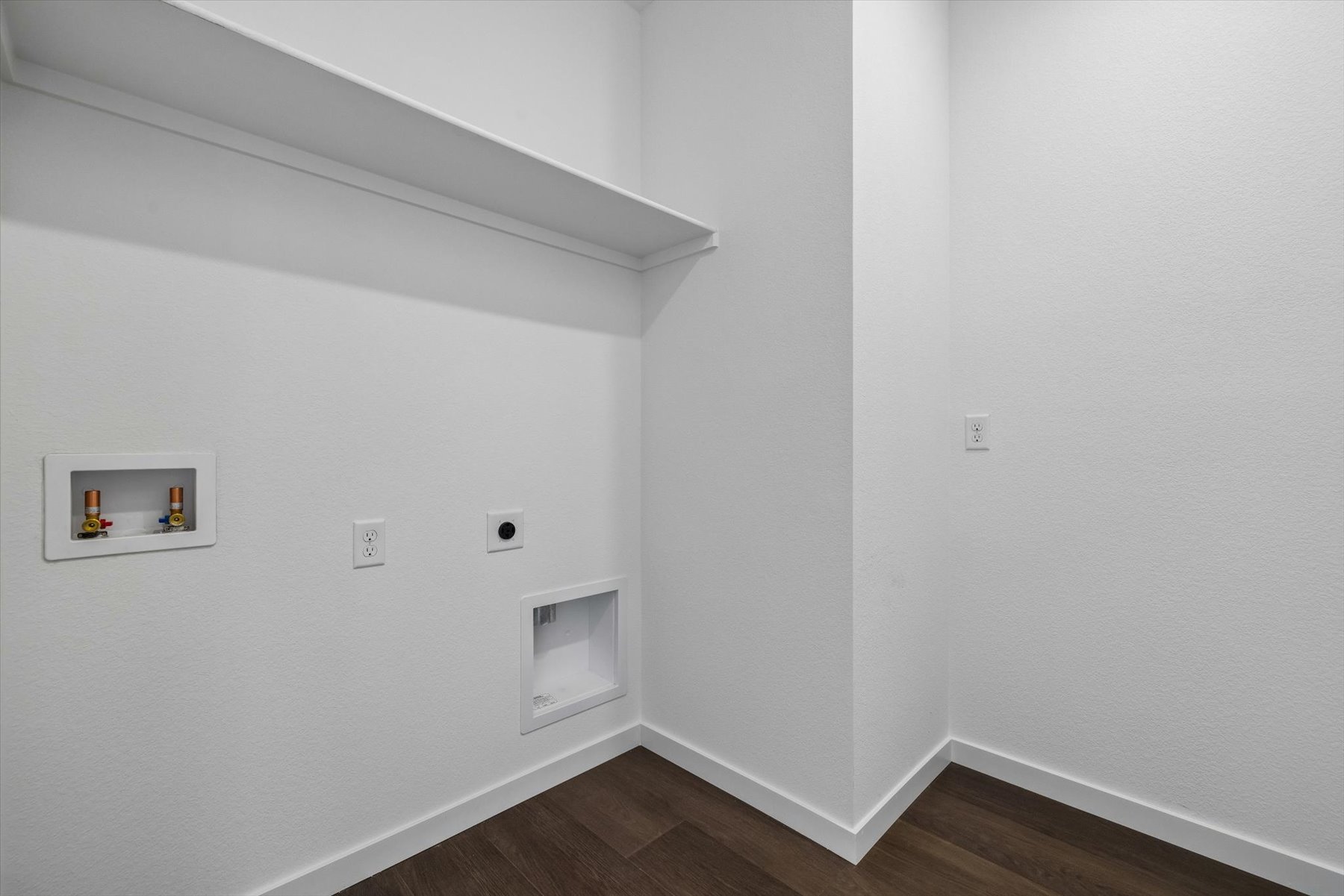 A white wall with pictures on it.