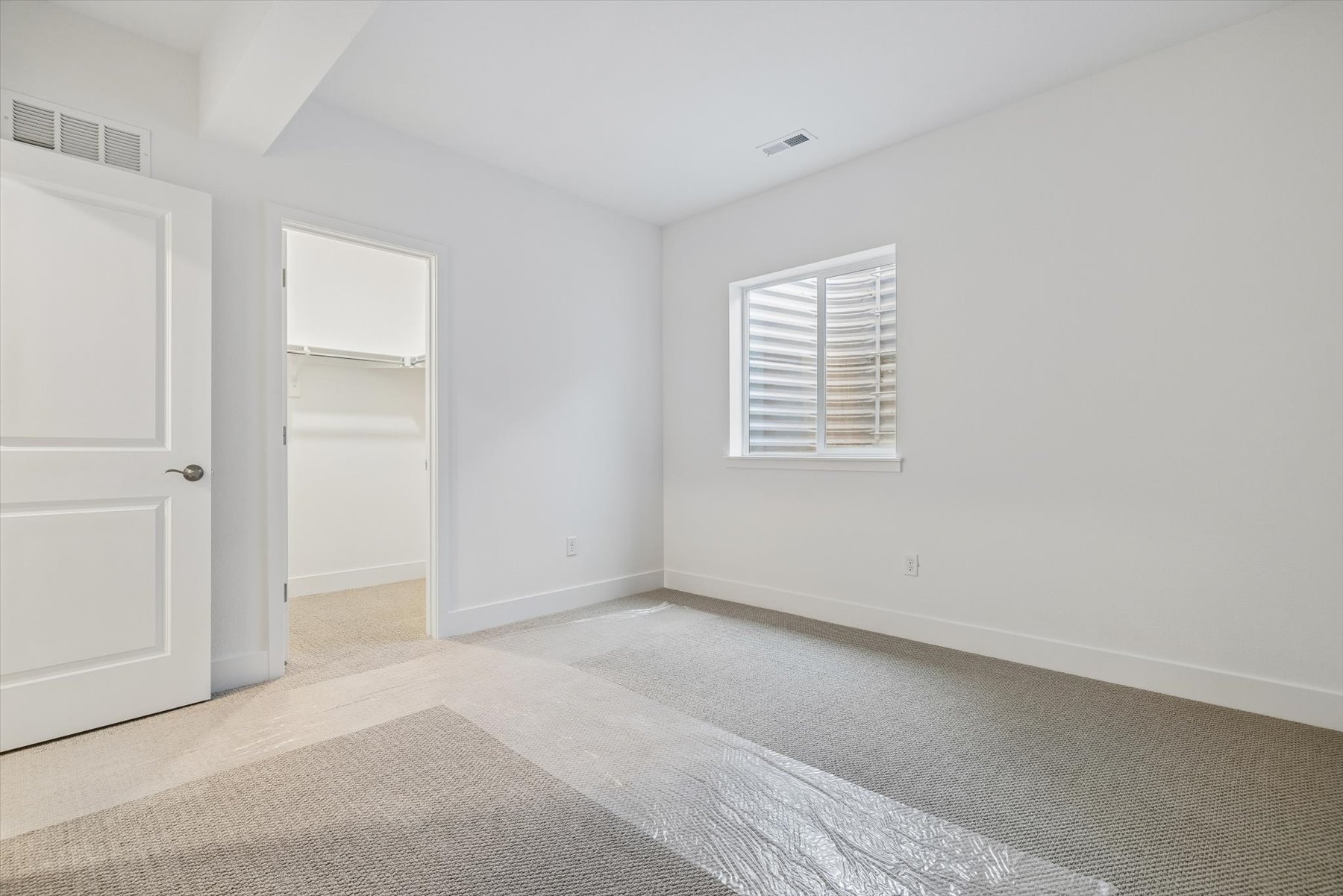 A room with a carpet and a rug.