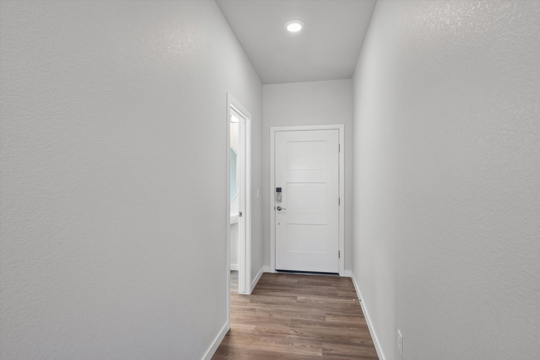 A hallway with white doors.