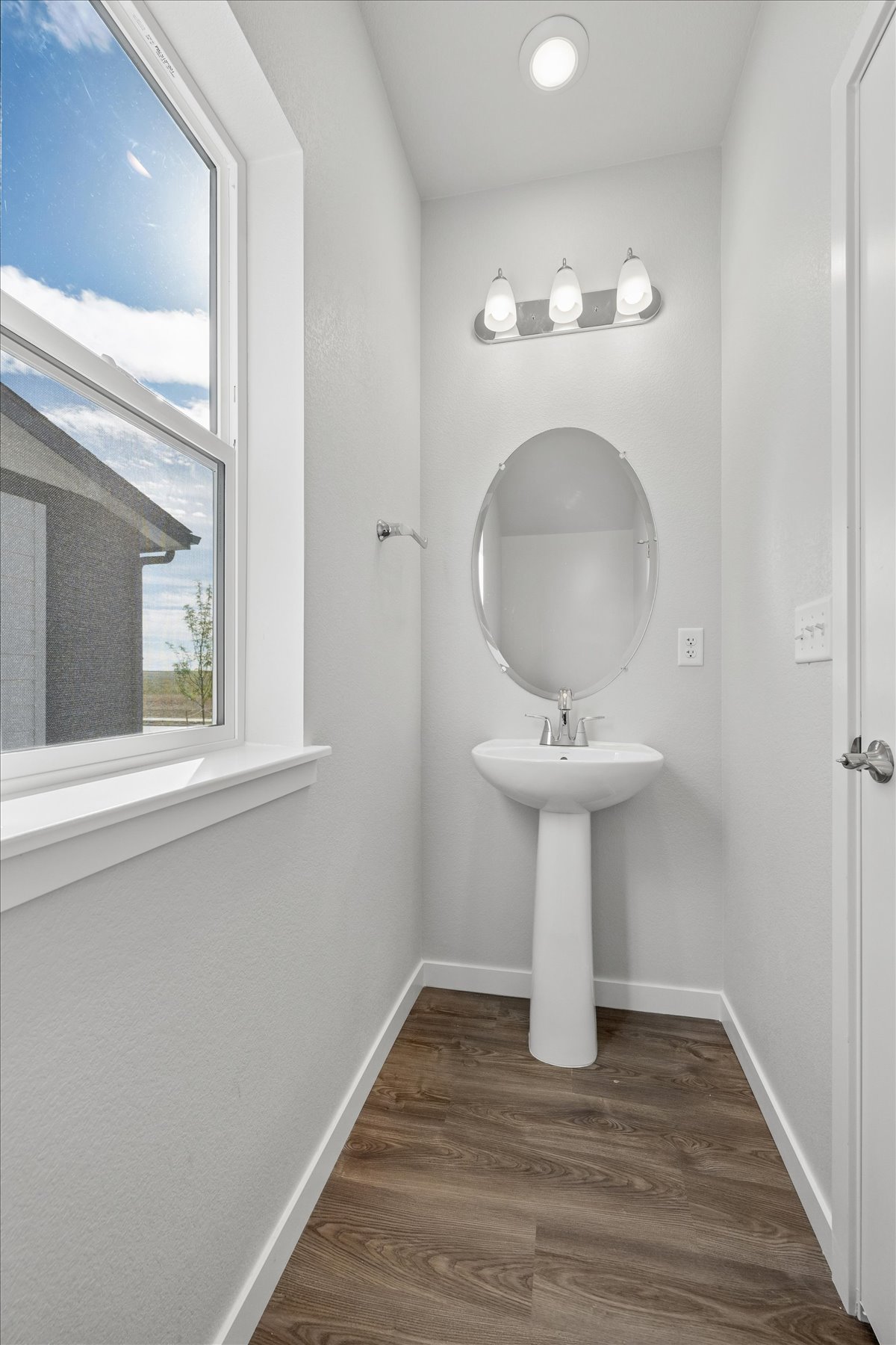 A bathroom with a mirror and sink.