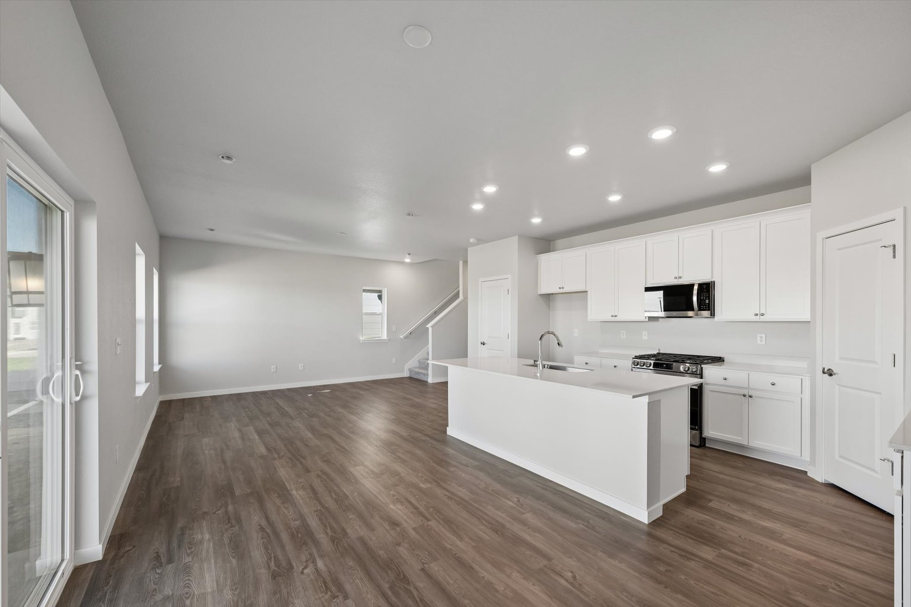 A kitchen with white cabinets.