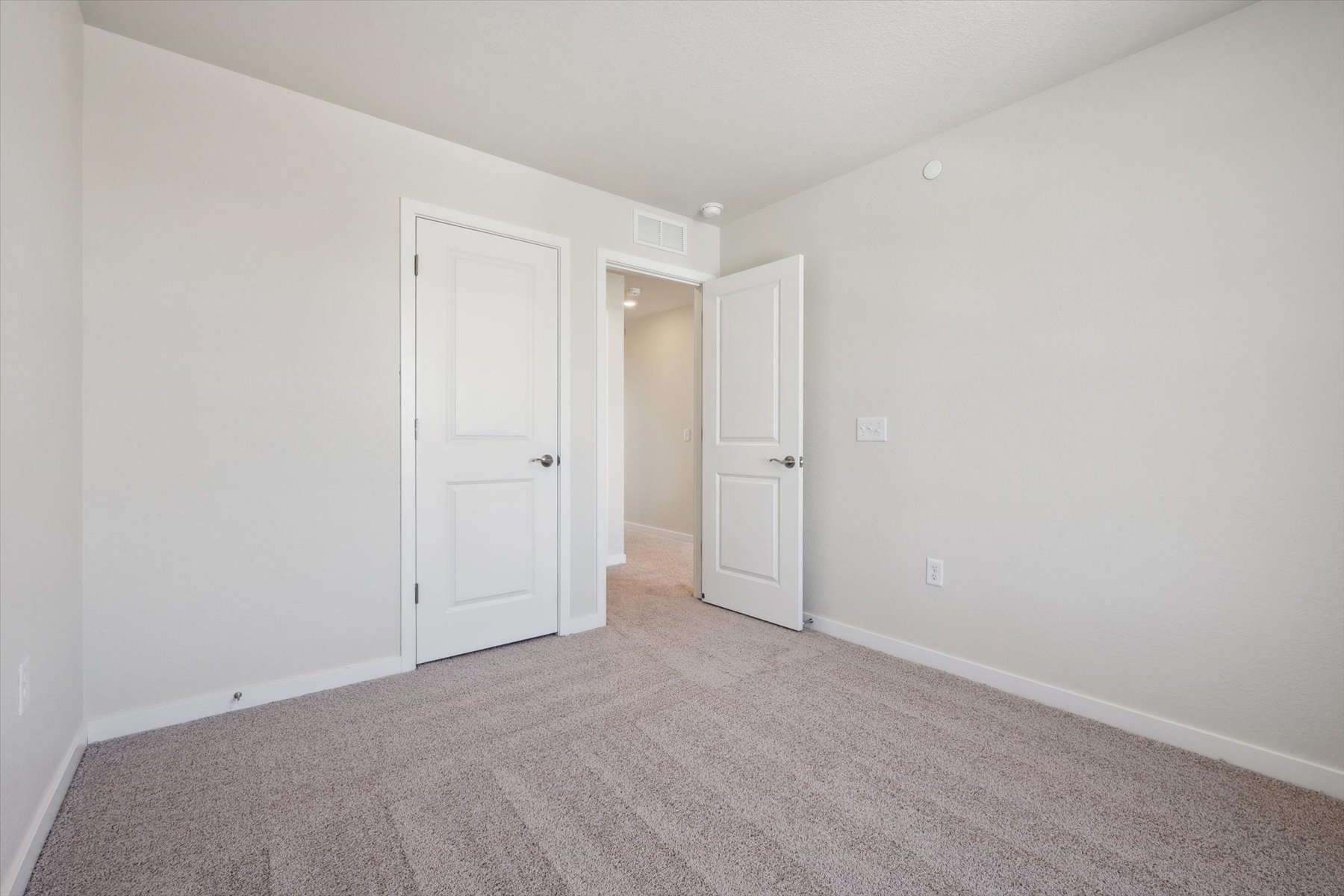 A hallway with white doors.