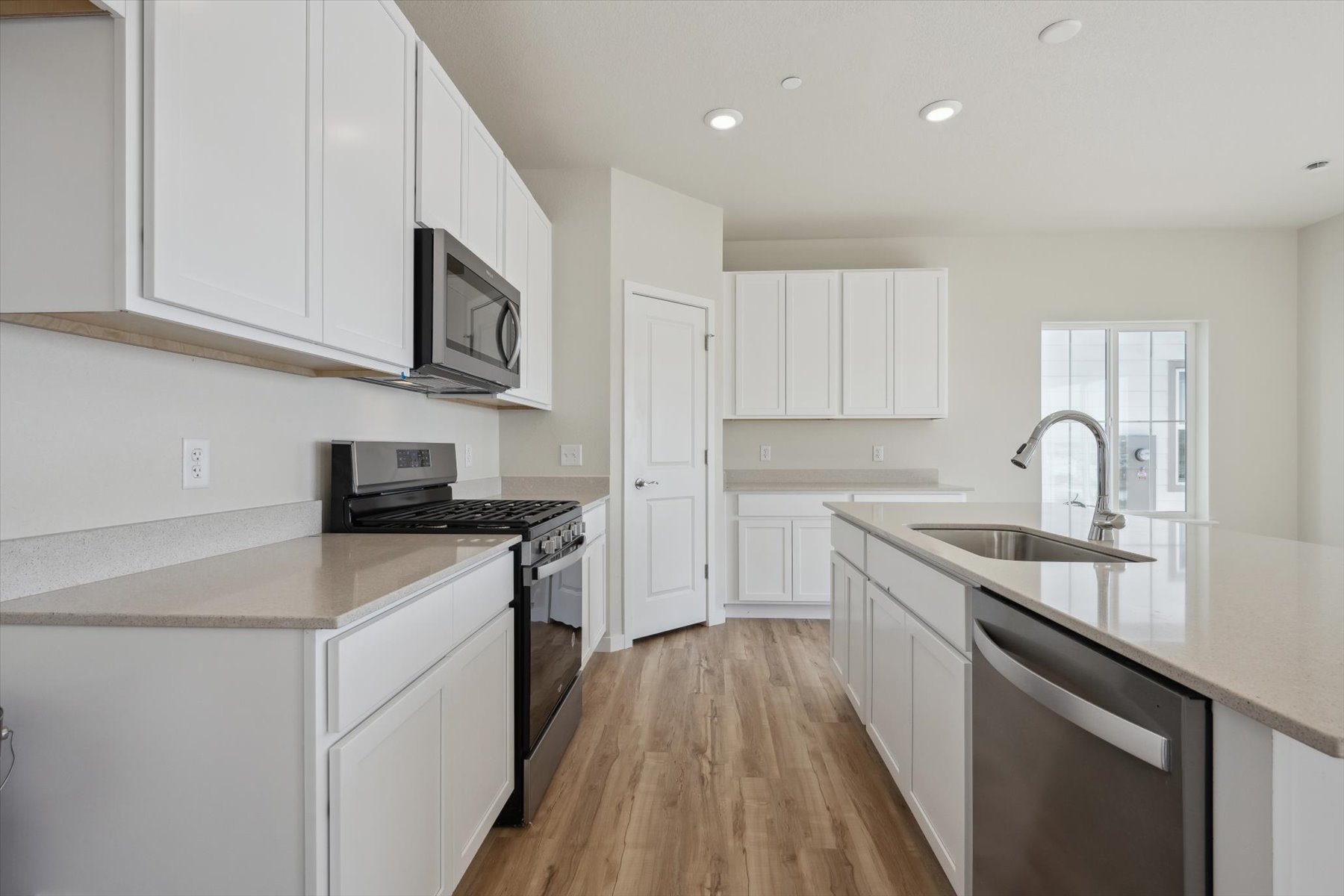 A kitchen with white cabinets.