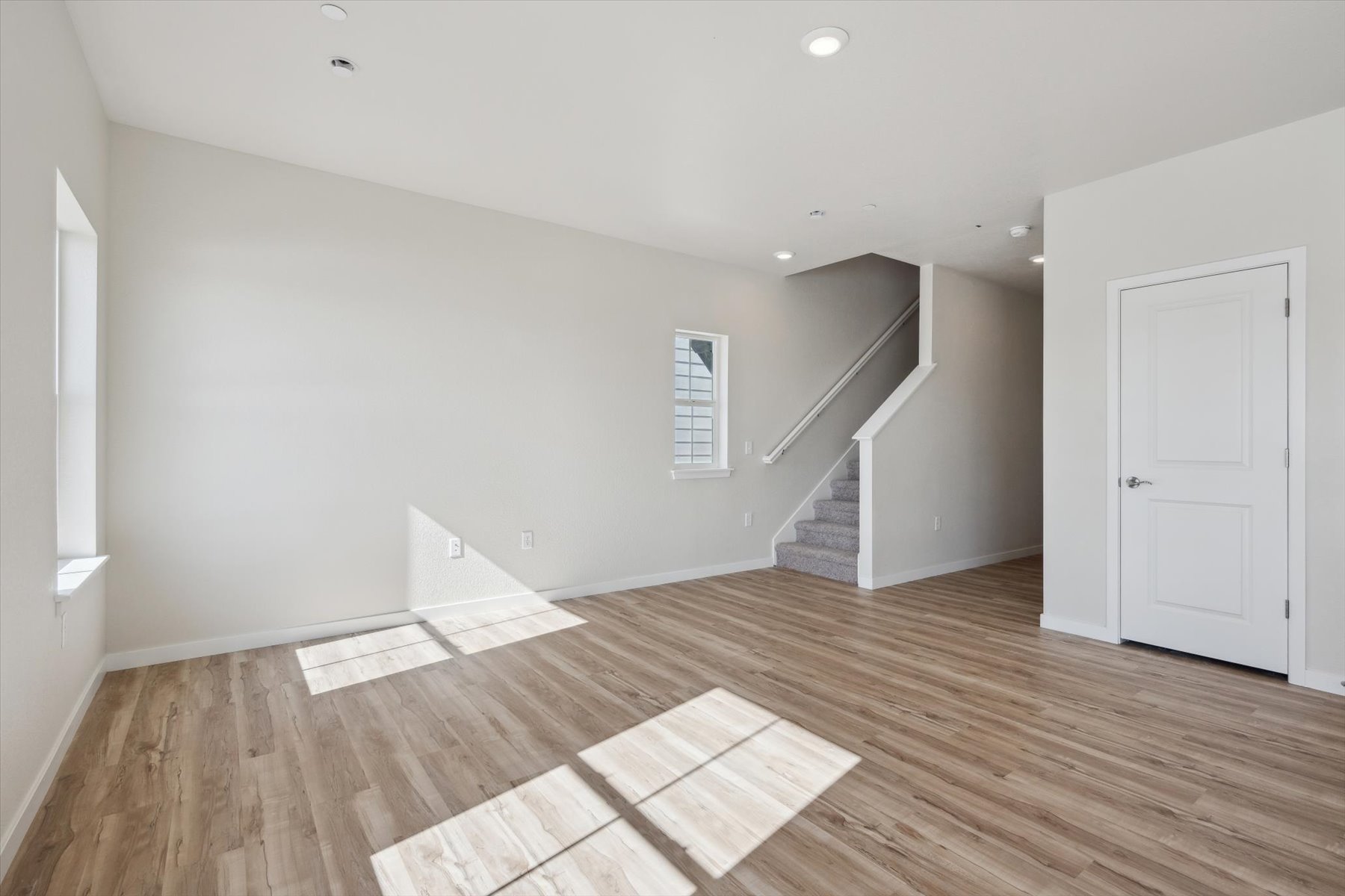 A room with a wood floor and white walls.