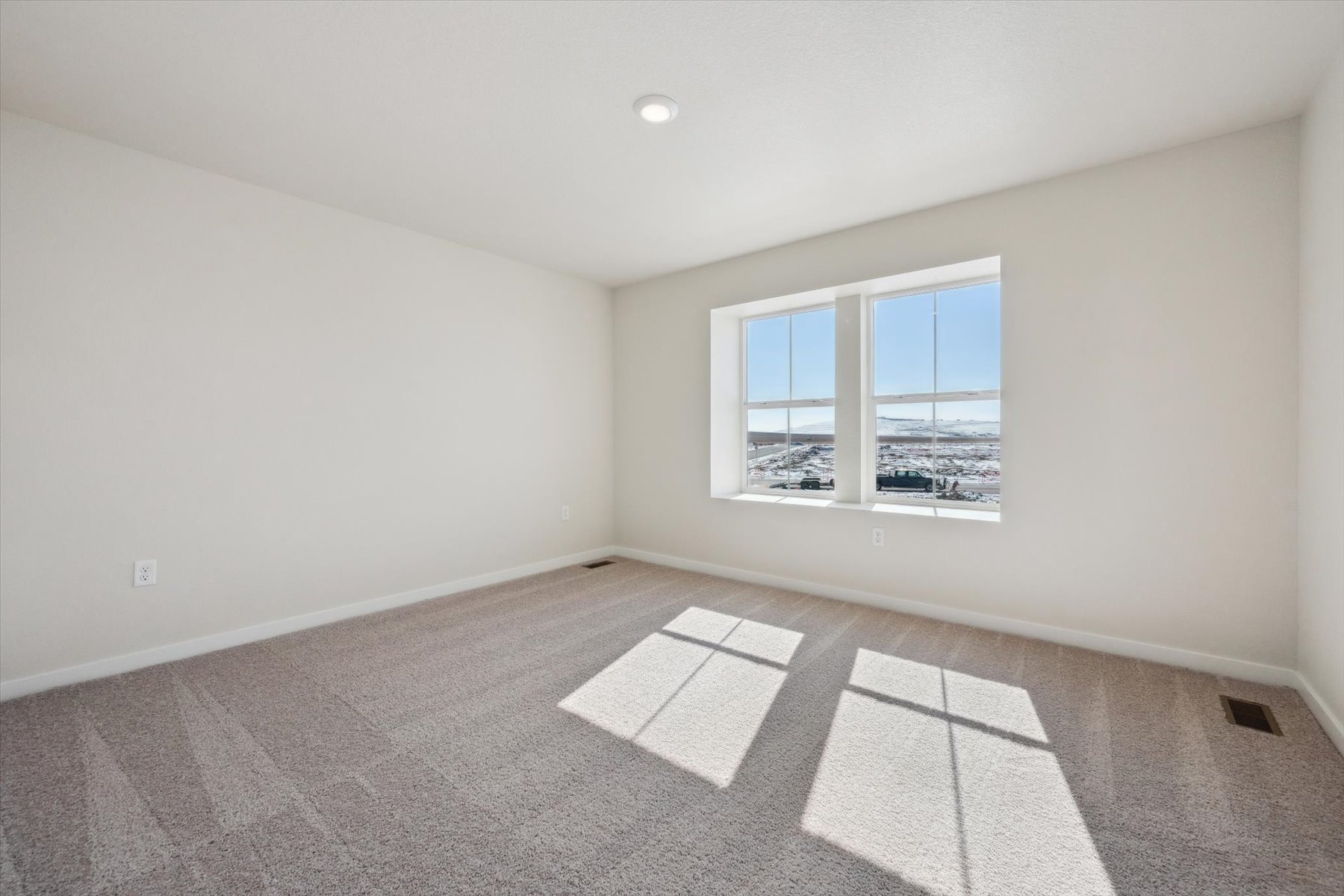 A room with a window and a tile floor.