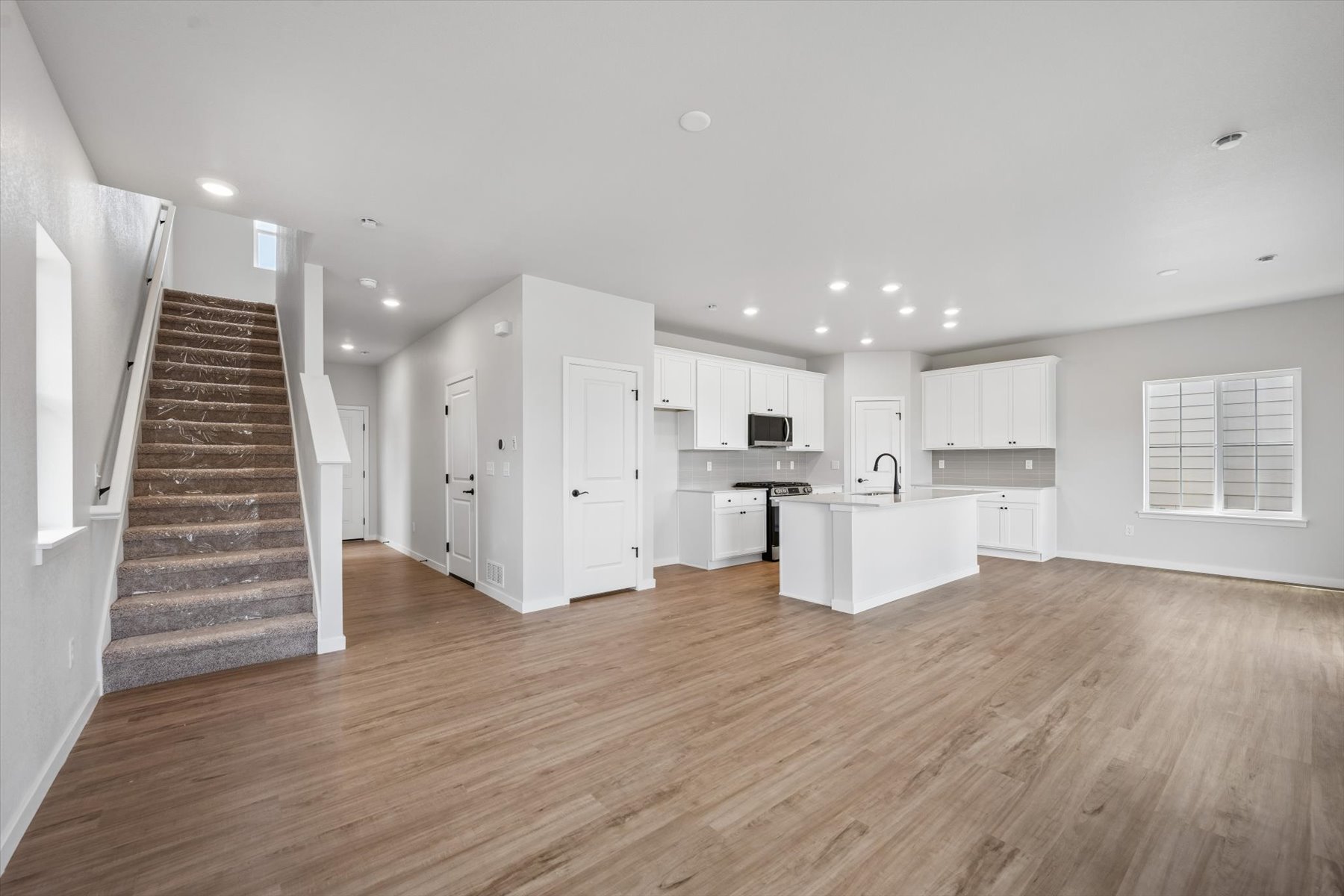 A large kitchen with white cabinets.