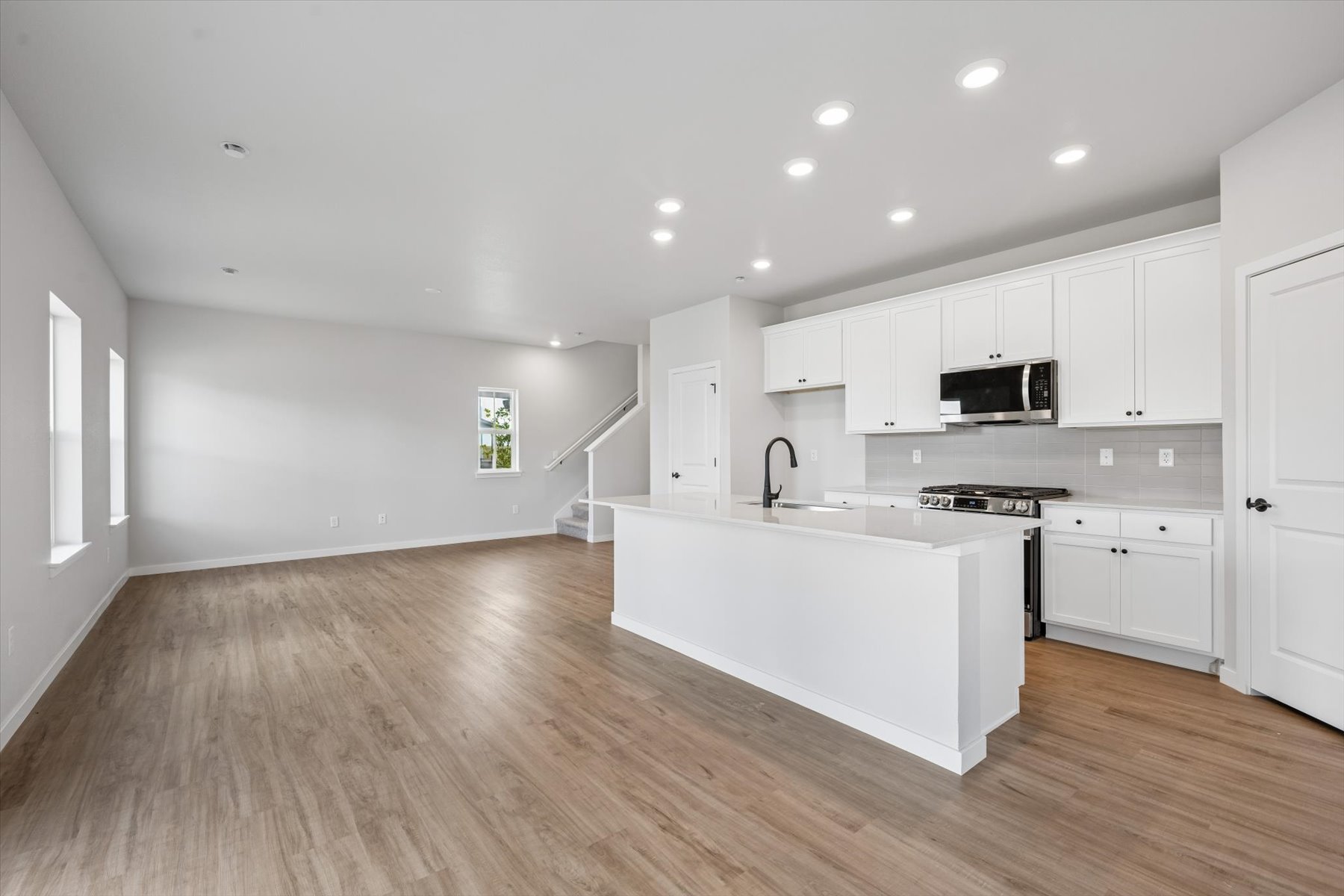 A kitchen with white cabinets.