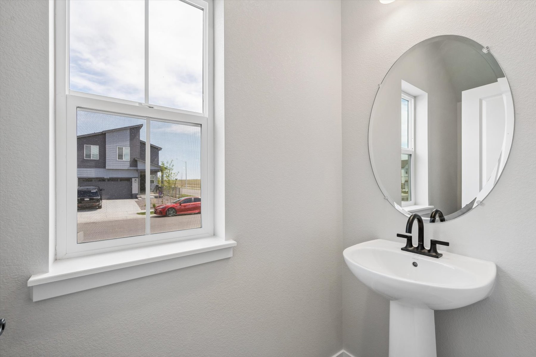 A bathroom with a sink and a mirror.