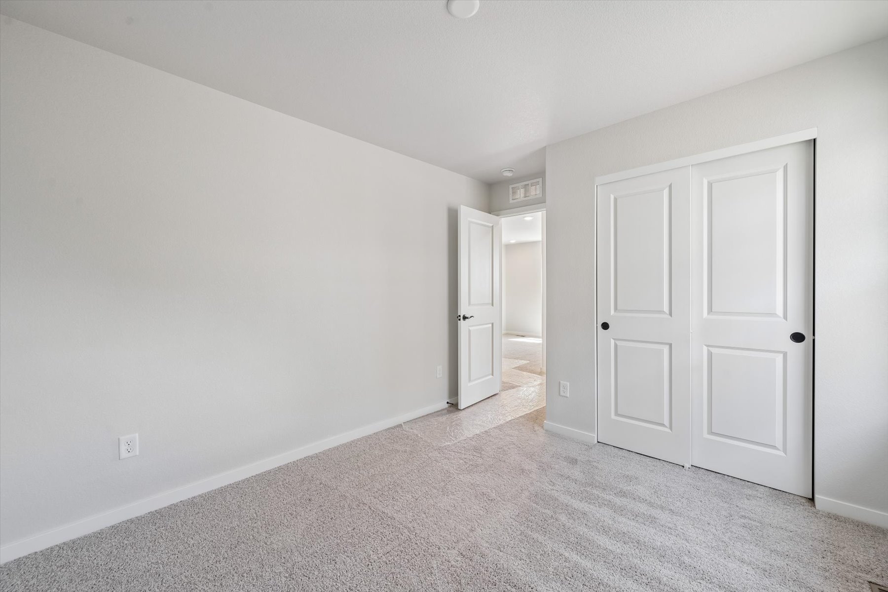 A hallway with white doors.