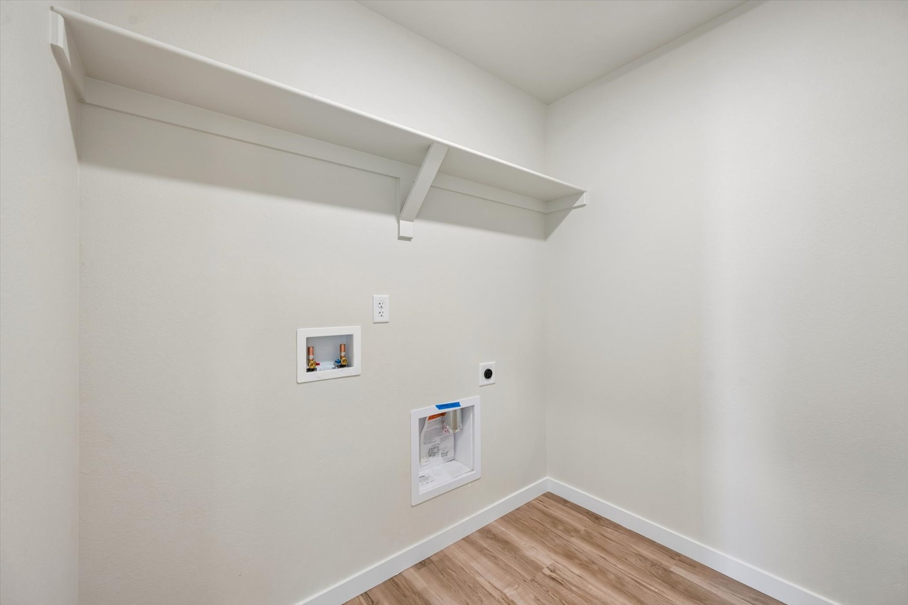 A white wall with pictures on it.