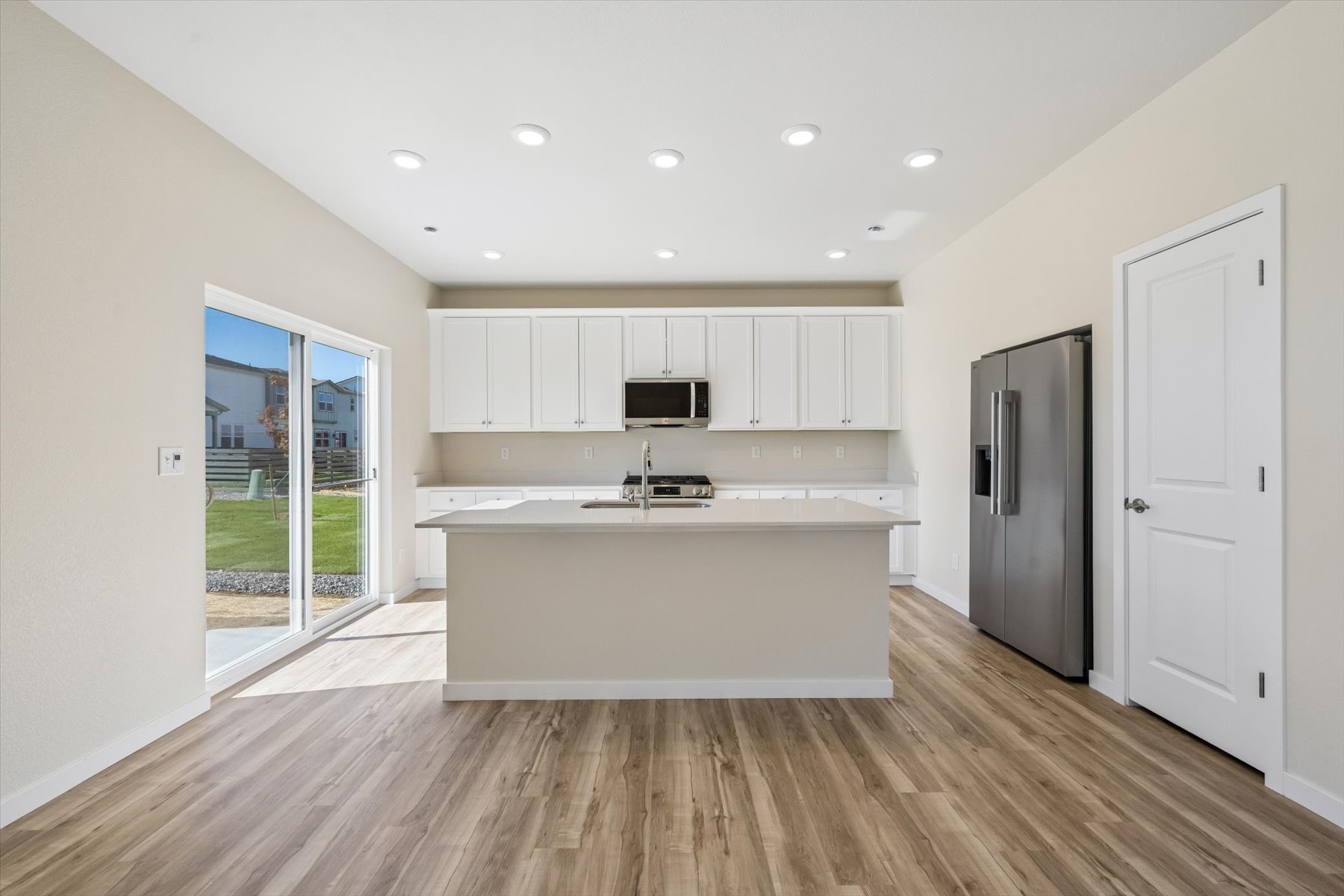 A kitchen with white cabinets.