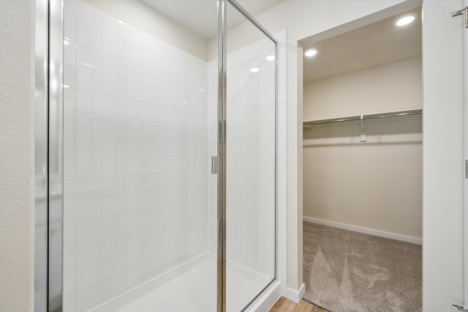 A shower with a glass door.