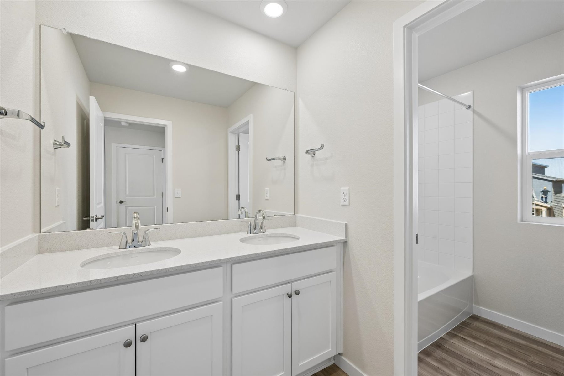 A bathroom with a shower and sink.