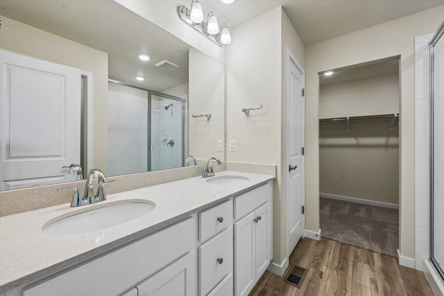 A bathroom with a large mirror.