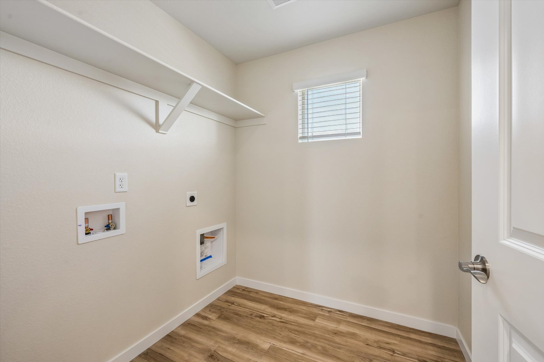 A room with a wood floor and white walls.