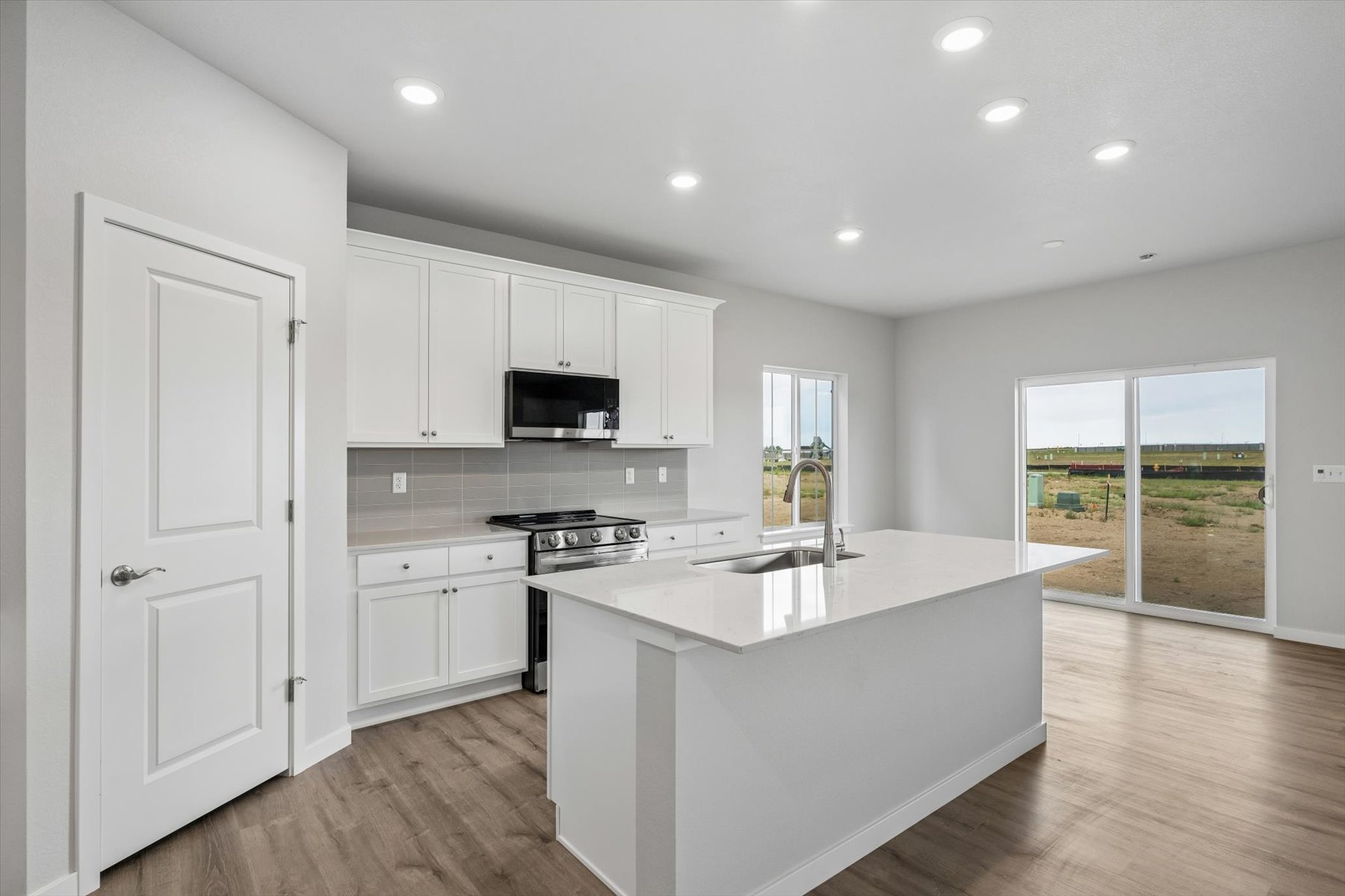 A kitchen with white cabinets.