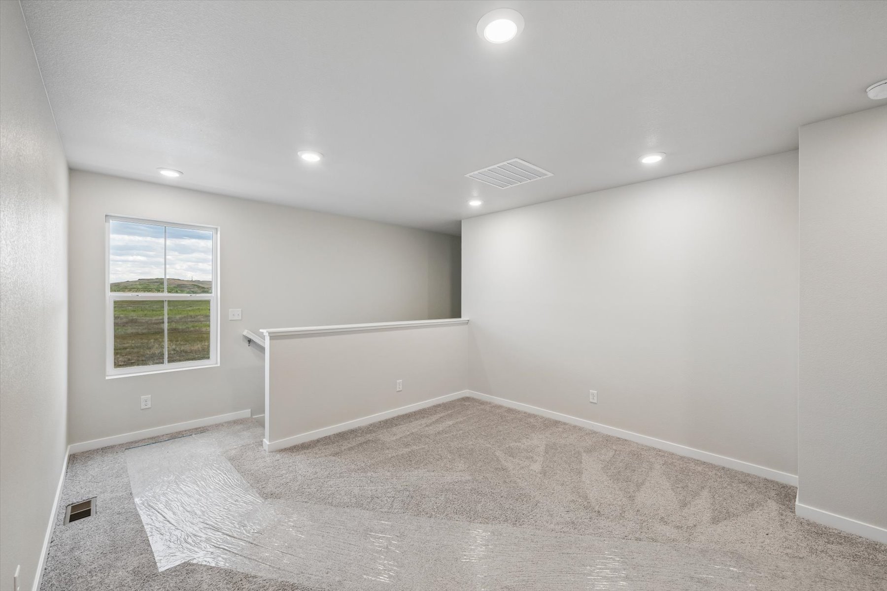 A room with a white floor and a window.