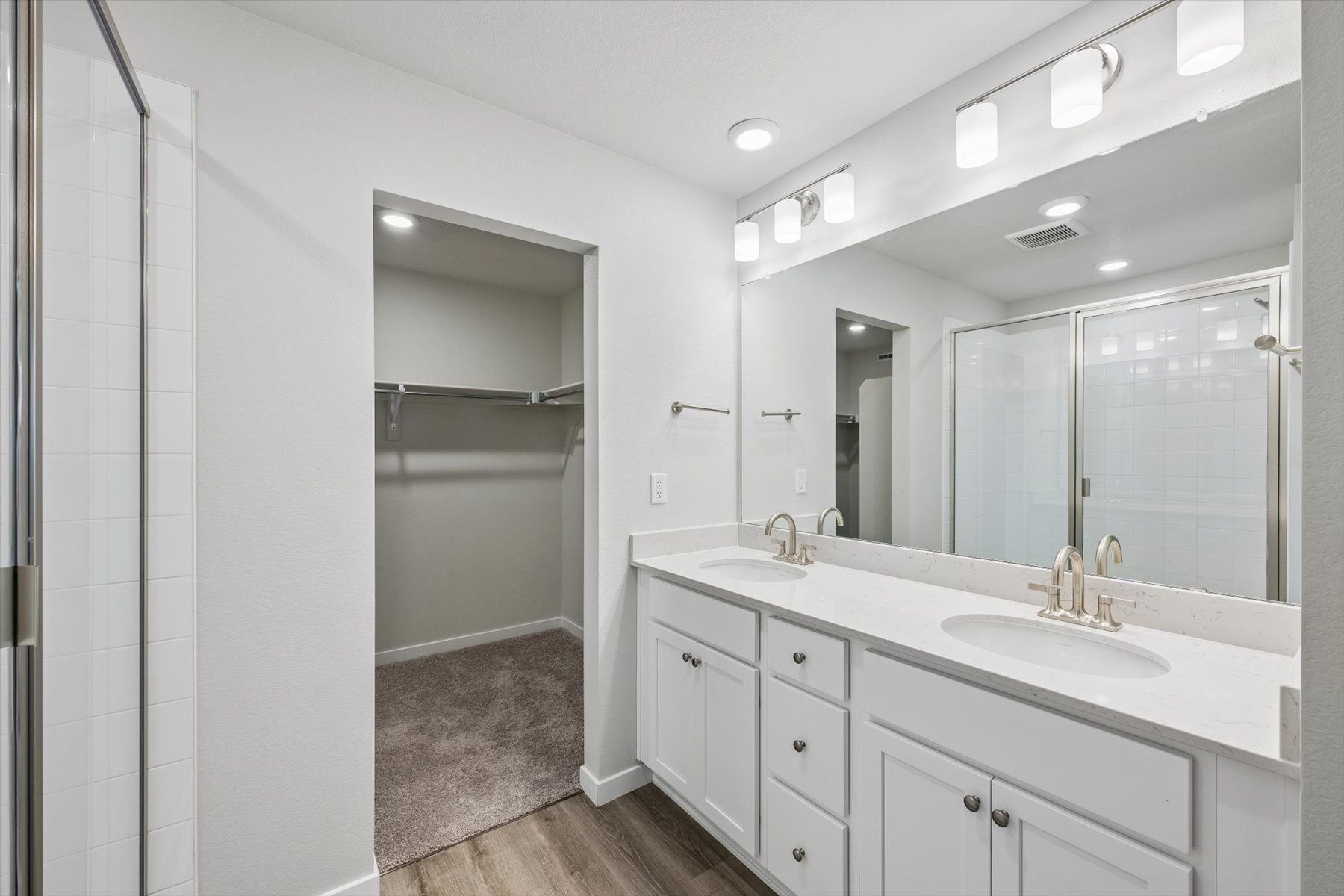 A bathroom with a shower and sink.