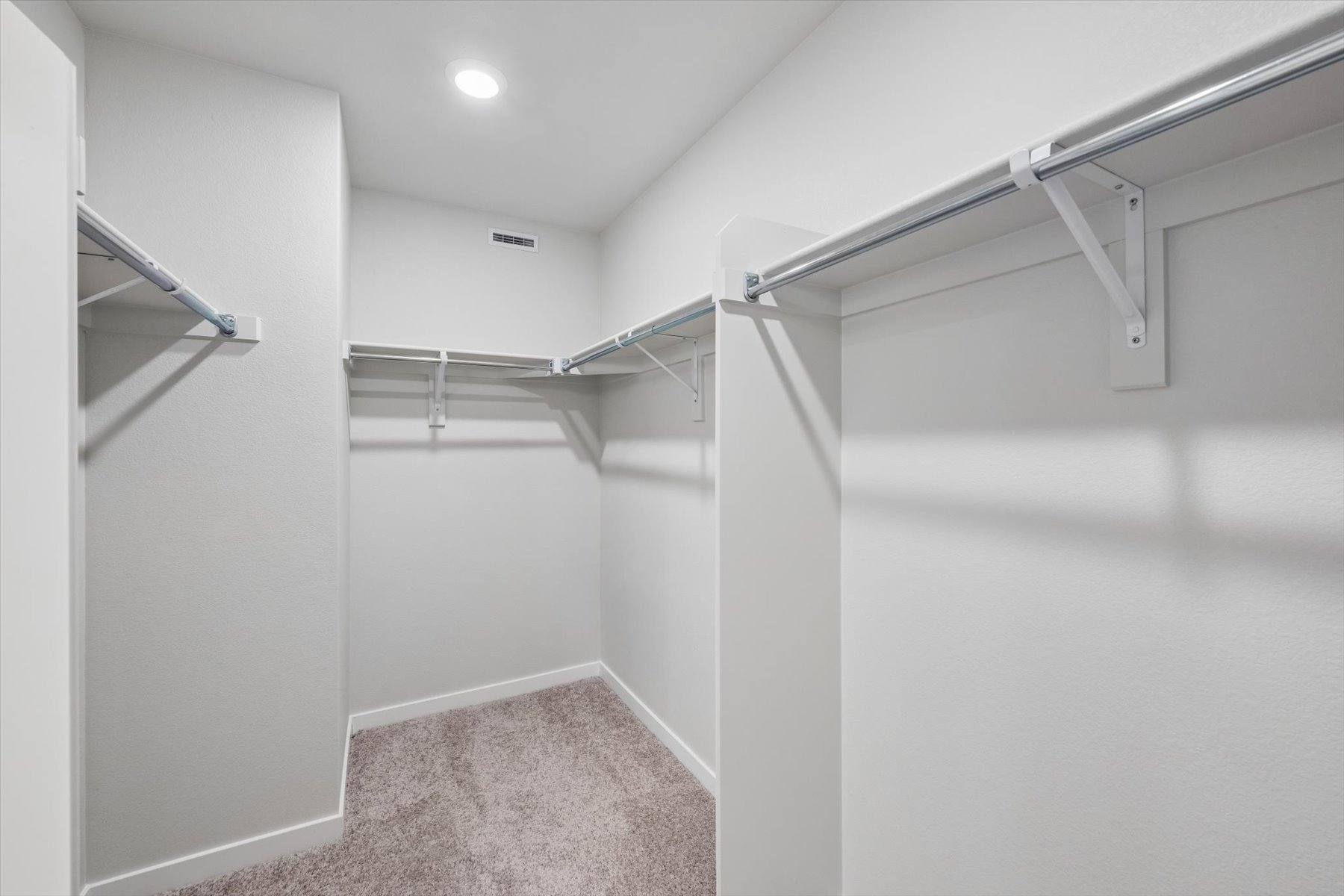 A white staircase with a light on the side.