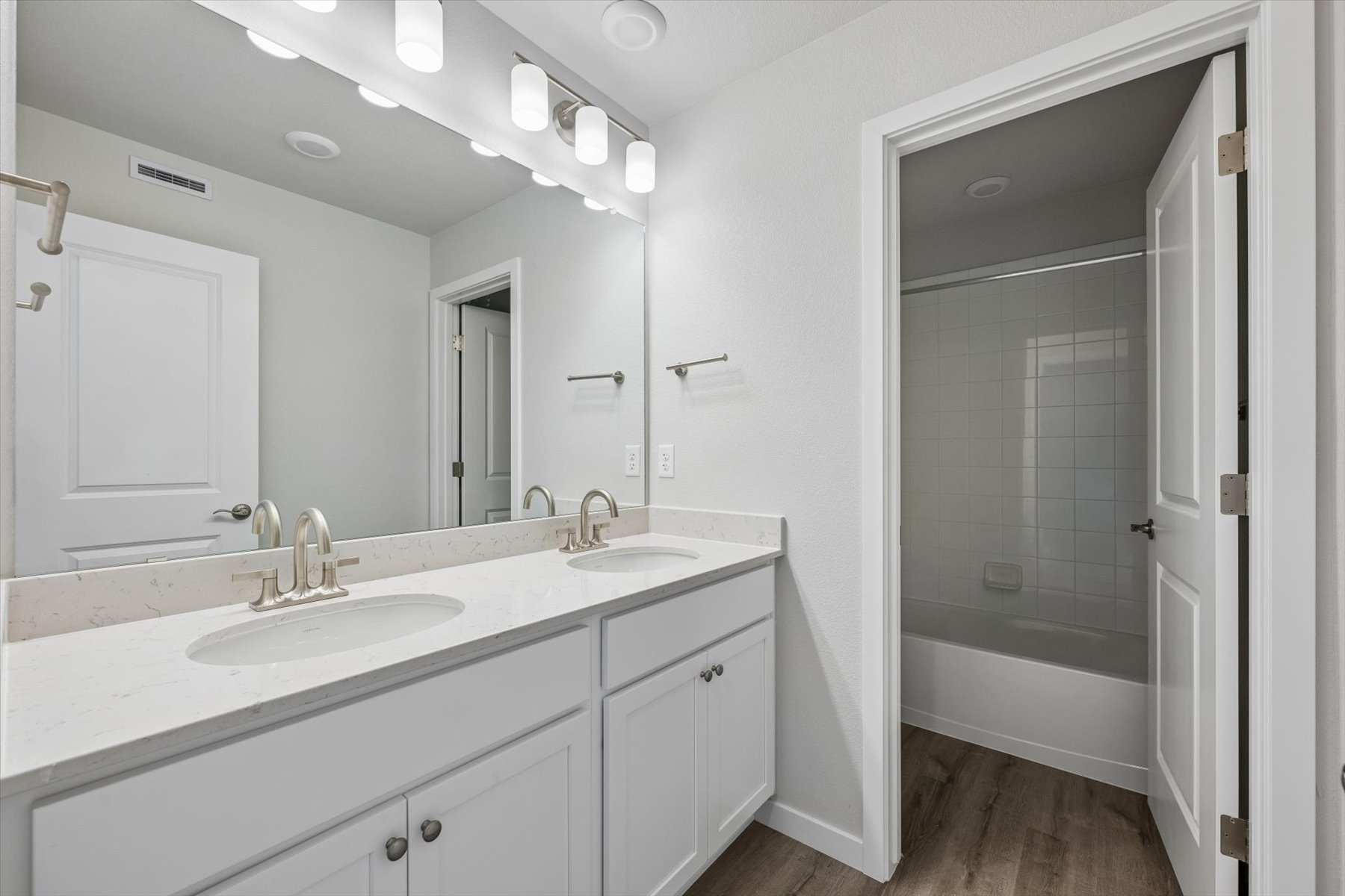 A bathroom with a sink and a shower.