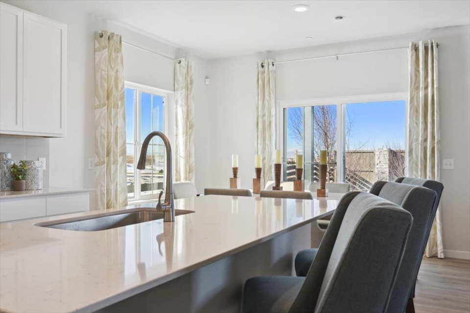 A kitchen with a large dining table.