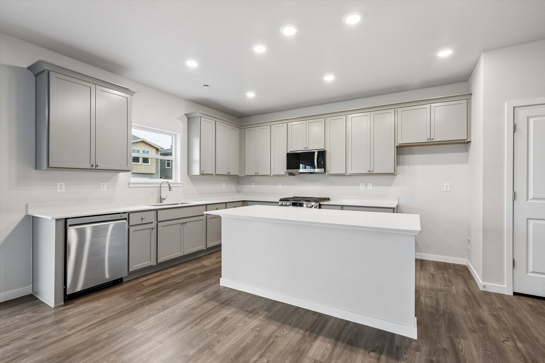 A kitchen with white cabinets.