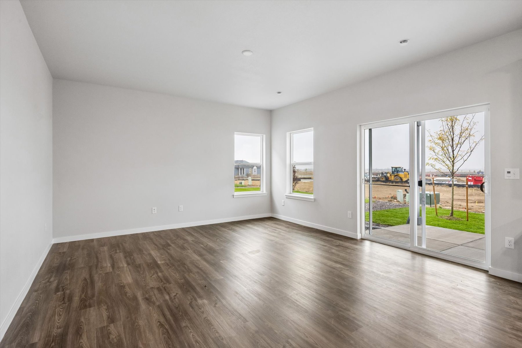A room with a wood floor and a glass door.