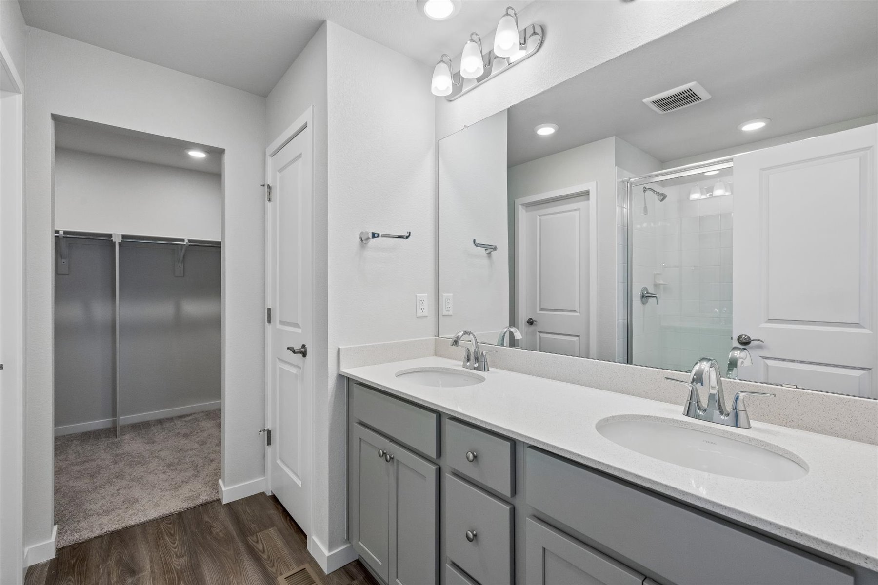 A bathroom with a large mirror.