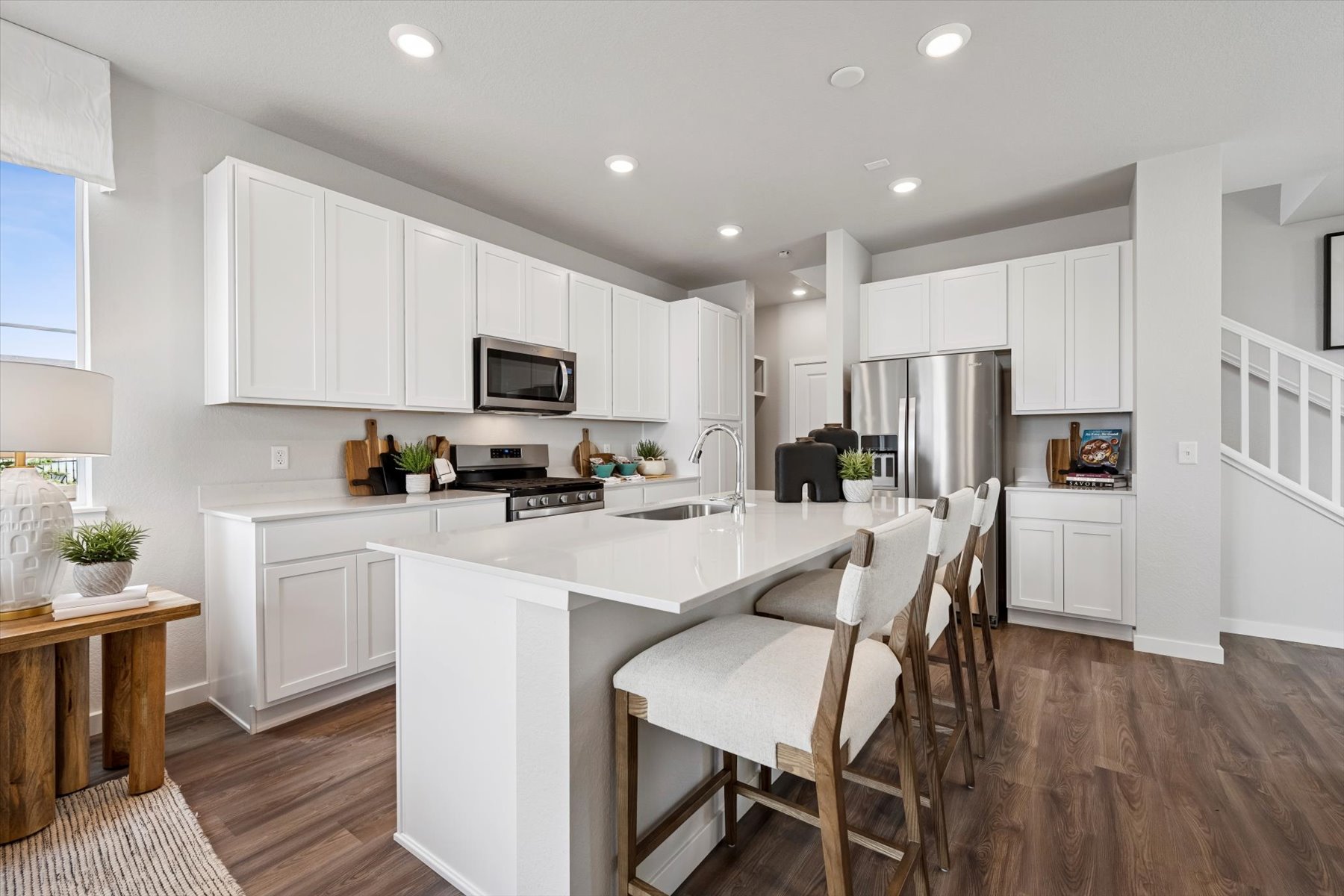 A kitchen with white cabinets.
