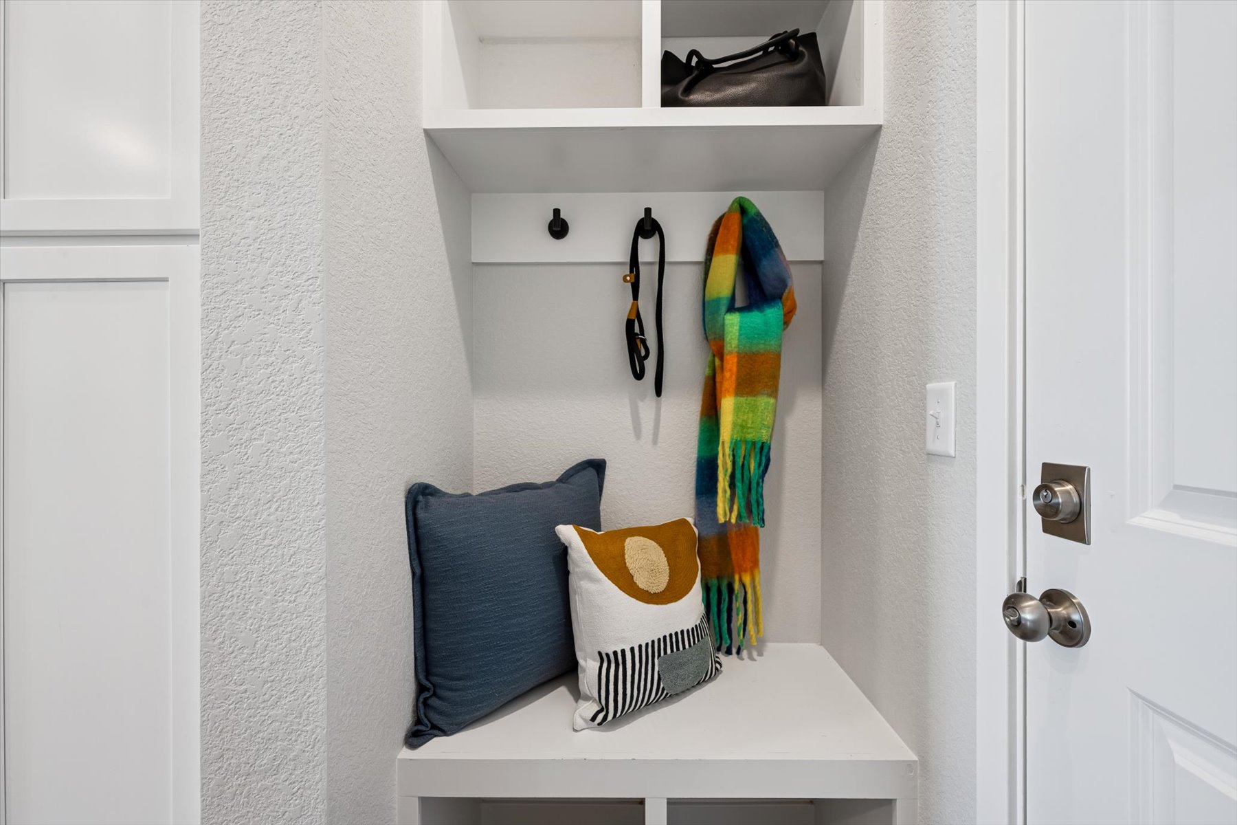 A closet with a couple of towels and a pair of shoes.