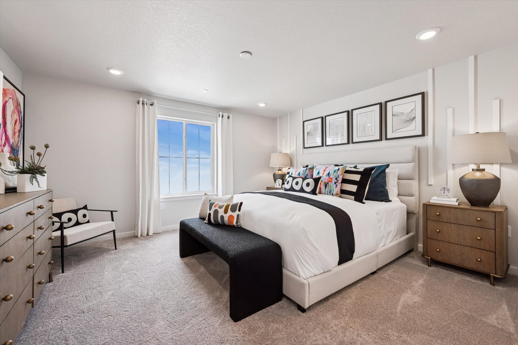 A bedroom with a bed and dresser.